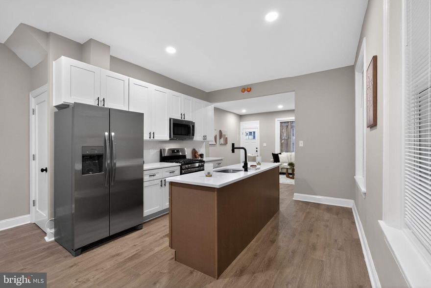 Welcome to this beautifully renovated 4-bedroom, 2.5-bathroom home located in the heart of Philadelphia. The main level has been completely redone and features brand-new laminate wood flooring throughout the living room, dining room, and kitchen, creating a seamless and modern flow. The stunning kitchen has been fully renovated with white shaker cabinets, granite countertops, chic black hardware, and stainless steel appliances. A stylish center island with wood-toned shaker cabinetry, white granite countertops, and a built-in dishwasher adds both functionality and visual appeal. A newly renovated half bathroom completes the main level.
The second floor offers three spacious bedrooms, all finished with brand-new wall-to-wall plush carpeting, along with a newly renovated full bathroom. The third level is dedicated to the expansive primary suite, featuring brand-new plush carpeting and a truly impressive en-suite bathroom. This oversized bathroom includes new ceramic tile flooring, a soaking tub, a separate glass-enclosed shower, a high-end vanity, and a new commode, offering a spa-like retreat. Additional highlights include brand-new central air conditioning, making this home completely move-in ready.