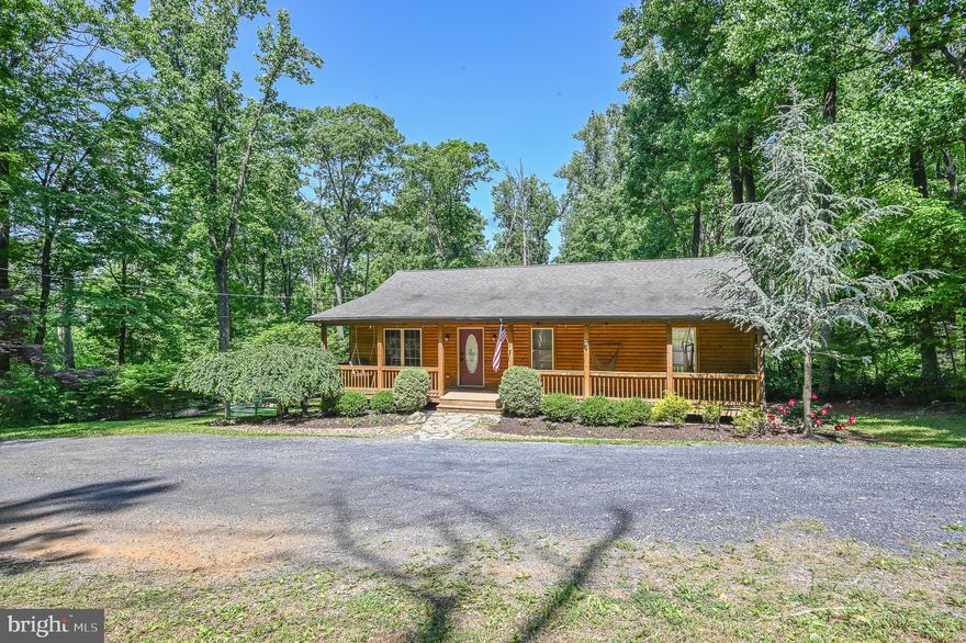 Property qualifies for 10k grant program through Journey Home/Welcome Home grant program with just 3% down payment! Some restrictions apply. Reach out to listing agent for more details! Just reduced 20K for immediate sale! Experience your own slice of paradise nestled in the mountains with this newly listed, breathtaking rambler boasting a charming log exterior. Situated on a rare flat lot, this property offers the convenience of a circular driveway, welcoming you to a majestic front porch that seamlessly blends with the mountain landscape. Mature landscaping surrounds the home, providing a private oasis while ensuring you don't have to compromise on modern comforts. Step inside to discover an expansive family/dining room adorned with real wood-planked walls and ceilings, accentuated by freshly installed premium luxury vinyl plank flooring throughout the main level.

Make your way to the back of the house and prepare to be impressed by the well-appointed kitchen, complete with stainless steel appliances, ample cabinet space, and tasteful wood accents. The main level is further complemented by three generously sized bedrooms, including a master bedroom with an attached bath, as well as a spacious hall bathroom adorned with a reclaimed wood accent wall.

Descend to the lower level and be greeted by an enormous fourth bedroom featuring a sitting area, a walk-in closet, and a third full bathroom. Additionally, you'll find a water treatment system, plentiful storage space, and convenient double door access to the backyard. Venture outside to discover a fully fenced oasis complete with a large fire pit, a kids' play set, and a sizeable shed, all set against a lush, green backdrop that exudes tranquility and seclusion.

Rest easy knowing that high-speed internet is available, ensuring you can stay connected while enjoying this idyllic retreat. Take advantage of the property's prime location, with a quick five-minute drive to the private beach/lake within the community and only a 15-minute commute from the convenience of Highway 66.