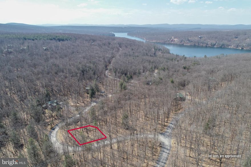 Building lot located in the premier subdivision - Gallatin Woods! This beautifully wooded community is located in the heart of the Deep Creek Lake. This is a condominium ownership type in regards to the land itself, but is buildable for a single family home! There are 8 pre-approved building plans designed and engineered by Mountaineer Log Homes that range anywhere from 1571 to 3908 square feet. This development has public sewer throughout, and each lot requires its own well. Tremendous opportunity to build a gorgeous vacation home with the added benefits of limited yard maintenance and work! Minutes to all area amenities: Deep Creek Lake State Park, the Wisp Resort, restaurants, shopping, and much more.
