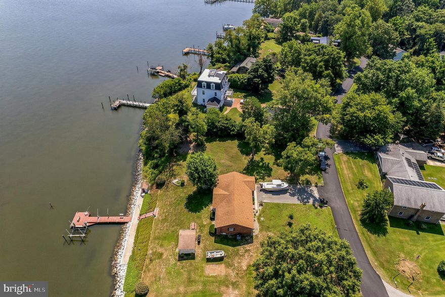 Escape the madness and immerse yourself in the breathtaking vistas of this captivating waterfront property. Prepare to indulge in the joys of fishing, crabbing, and boating as you step foot onto this remarkable property. This meticulously maintained 2-bedroom, 2-bathroom home boasts a one-car garage, a cozy living room, an open kitchen, and sweeping panoramic views that will leave you in awe. Discover the rarity of a property with a rip-rapped shoreline including a concrete pad platform and waterfront pleasures.
Unleash your angler's spirit and set up your fishing rods and crab pots on the 60 ft pier .A recently installed 10,000 boat lift is ready for use. Additionally, two manual lifts are ideal for accommodating small boats, crab pots, or oyster floats. This perfect-sized home and property present a great opportunity for weekend getaways or full-time living.
Located in the community of Hollywood Shores,  you can join the Civic Association and access the nearby pool and boat ramp. Neighborhood activities are offered year-round and new friends and neighbors are ready to welcome you. With every convenience at your fingertips, this waterfront home promises a truly wonderful living experience.