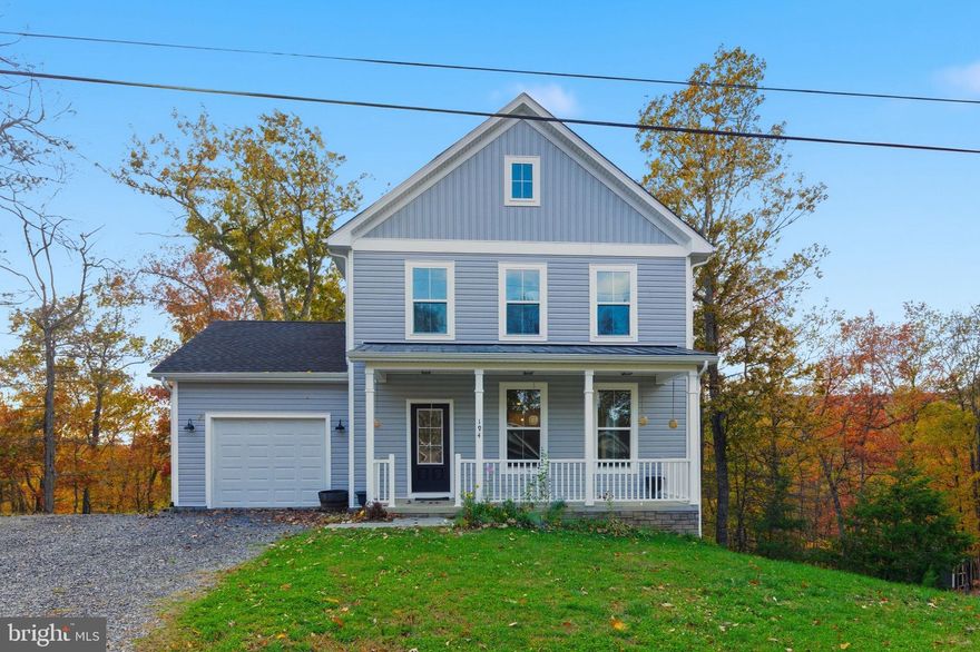 Welcome to The Woods Resort! As one of the newest homes in the community, this recently built colonial is just 2 years young and still shows like new. The main level features an open concept with a beautiful kitchen, perfect for entertaining and enjoying each moment. Get cozy by the fire place, grill and chill on the back deck, or enjoy your morning coffee under the covered front porch. Upstairs, you'll find 3 bedrooms and 2 full baths, including the primary suite with walk-in closet, double vanity, and tile shower. The unfinished basement is left for you to add your touch and features a rough-in to add another future bathroom. Located in a cul-de-sac, the lot is just shy of 1 acre and is backed by woods if you love to hunt! The Woods Resort spans over 1,800 acres of lush forests and rolling hills, perfect for relaxation or outdoor enthusiast. Known most for its spas and golf course, the Woods is just 90 minutes from D.C. and Baltimore. Whether you need a weekend getaway or a full time residence away from the hustle and bustle, this home is perfect for you!