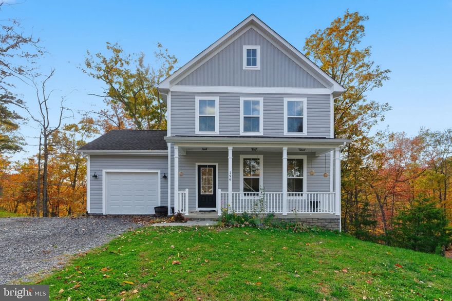 Welcome to The Woods Resort! As one of the newest homes in the community, this colonial, recently built in 2023, still shows like new. The main level features an open concept with a beautiful kitchen, perfect for entertaining and enjoying each moment. Get cozy by the fire place, grill and chill on the back deck, or enjoy your morning coffee under the covered front porch. A half bath is on the main level for convenience. Upstairs, you'll find 3 bedrooms and 2 full baths, including the primary suite with walk-in closet, double vanity, and tile shower. The unfinished basement is left for you to add your touch and features a rough-in to add another future bathroom. Located in a cul-de-sac, the lot is just shy of 1 acre and is backed by woods, perfect for hunters! The Woods Resort spans over 1,800 acres of lush forests and rolling hills, perfect for relaxation or outdoor enthusiast. Known most for its spas and golf course, The Woods is just 90 minutes from D.C. and Baltimore. Whether you need a weekend getaway or a full time residence away from the hustle and bustle, this home is perfect for you!