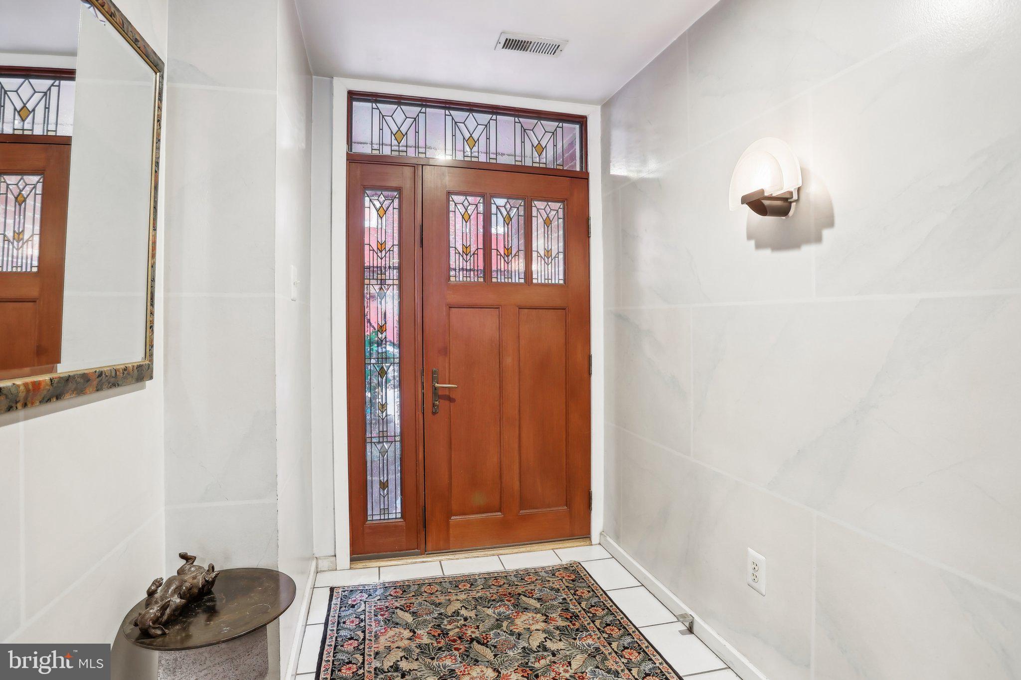 Don't miss out on this AMAZING home in the coveted LOGAN SQUARE section of Center City, Philadelphia! This EXTRA WIDE home with over 2,500 sq. ft, offers ATTACHED GARAGE PARKING, which is hard to come by in this area. NO HOA fees! It is located in the competitive GREENFIELD SCHOOL CATCHMENT. This home features 4 Bedrooms with an additional spacious loft that can be converted into an additional bedroom, 3 Full Bathrooms, + a 1/2 Bath, and 3 OUTDOOR SPACES. This light-filled entry-level includes the 1/2 Bathroom, laundry area, and a large open den with a fireplace that leads to sliding doors onto a spacious patio. Make your way up to the main level with an open living and dining room with hardwood floors. The beautiful stained glass doors lead to a walkout balcony. Steps away is the stunning kitchen with an abundance of natural light featuring a cozy breakfast nook that can seat 6. Black cabinets and appliances complement the solid stone countertops and island perfectly. Head upstairs to 3 Bedrooms and 2 full bathrooms. The HUGE Primary Suite on this level features a custom walk-in closet and a beautifully tiled bathroom with a shower. The 4th Fl oasis is nothing you've ever seen before with another LARGE Bedroom with custom closets, and a bonus room overlooking the 3rd-floor primary suite. Step onto the roof deck from this room for some fresh air. The huge custom bathroom features a full-size SAUNA, spacious shower, jacuzzi tub, and sitting area! 137 N 22nd St is convenient to all major highways. Walking distance to Trader Joe's, a new Giant supermarket, Whole Foods, The Philadelphia Museum of Art, Rittenhouse Square, and so much more! Make your appointment today!