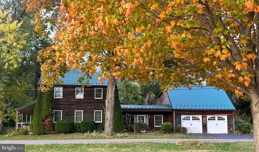 Welcome home to this charming farmhouse on 5.41 acres in Mechanicsburg! Built in the late 1800s, this well-maintained home blends timeless farmhouse character with thoughtful modern updates.  

Inside, you’ll find a custom cherry kitchen thoughtfully designed with quality craftsmanship, while the family room features pine vaulted ceilings and exposed beams, creating a warm and inviting atmosphere. Relax by the wood-burning fireplace or enjoy your morning coffee on the balcony overlooking peaceful, scenic views. The large bedroom above the garage, complete with a walk-in closet and full bathroom, offers flexibility as a luxurious second primary suite or private guest retreat.

The 5.41-acre property is perfect for anyone dreaming of having their own farmette! The township allows for farm animals, and there’s plenty of open space for gardening, homesteading, or hobby farming. Trails throughout the property are ideal for riding golf carts, dirt bikes, or 4x4s, offering endless opportunities for outdoor fun.

An original detached summer kitchen, now used for storage, adds history and charm, while the detached barn provides additional space for equipment, projects, or animals.

The exterior showcases beautiful cedar siding paired with a newer metal roof designed to last 40+ years, creating a rustic yet refined aesthetic. Updates include Anderson replacement windows, upgraded Andersen sliding doors in both the primary bedroom and family room, a new composite balcony off the primary suite, leaf-guard gutters, and a stamped concrete front porch. The heated and insulated two-car garage adds comfort and convenience year-round.

Practical updates provide peace of mind, including a newer private septic system, a full home and barn security system already wired, and a waterproofed basement with an extensive four-point sump pump system, ensuring a dry and secure foundation.

With its blend of rustic charm, modern comfort, and usable acreage, this property perfectly balances country living with convenience to Mechanicsburg amenities. Along with your own expansive land you can also enjoy the scenic two-mile walking path located just across the road. This property truly offers the best of both worlds—peaceful country living with convenience to everything Mechanicsburg has to offer. Located in Upper Allen Township, it’s just minutes from Messiah University, Oak Grove Farms, The Willows at Ashcombe Mansion, and Williams Grove Speedway. Enjoy easy access to shopping and dining at Silver Spring Square, as well as charming local restaurants in downtown Mechanicsburg. Country living with the convenience of quick access to Route 15 and the PA Turnpike.  If you’re looking for outdoor recreation, community events, or everyday amenities, this location has it all within a short drive.

The current owners have cherished this home for over 35 years, taking exceptional care of every detail and thoughtfully maintaining it through the years. Their pride of ownership shines through, making this home truly something special for the next owners to enjoy and make their own.