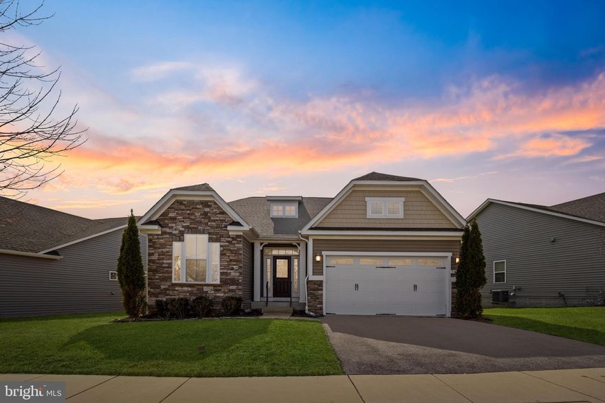 Tucked away in the highly sought-after Sanctuary at Two Rivers, 3061 Sunny Ridge Drive offers the perfect blend of comfort, style, and privacy. This beautifully designed ranch-style home sits on a premium lot with generous space between neighbors and serene views of the open field behind—ideal for peaceful mornings and bird-watching right from your backyard.

Inside, warm wood floors flow throughout the main living areas, while plush brand-new carpet adds comfort to each bedroom. A welcoming foyer leads into a versatile office space, which can easily double as a fifth bedroom, followed by a formal dining room—perfect for hosting gatherings.

At the heart of the home is a chef’s dream kitchen, complete with granite countertops, upgraded cabinetry, a striking Spanish tile backsplash, under-cabinet lighting, stainless steel appliances, a double oven, a natural gas cooktop, a spacious pantry, and a convenient breakfast nook. The open layout seamlessly connects to the expansive living room, where vaulted ceilings, recessed lighting, and a stunning stone natural gas fireplace create a warm and inviting atmosphere.

From the living room, sliding glass doors open to a screened-in composite deck—low-maintenance and ideal for relaxing outdoors. The uncovered portion of the deck offers additional space to soak in the sun or entertain guests.

The primary suite is a true retreat, featuring two walk-in closets and an updated en-suite bathroom with a double vanity and a luxurious walk-in shower. Two additional bedrooms, an updated hallway bath, and a laundry room with garage access round out the main level for ultimate convenience.

Downstairs, the expansive basement provides endless possibilities with a wide open space for entertaining, a full bathroom, a private bedroom with walk-out stairs, and an additional room ready to be converted into a sixth bedroom, home gym, or hobby space. A large storage/utility room ensures plenty of space to stay organized.

Beyond the home, The Sanctuary at Two Rivers offers an unparalleled lifestyle with resort-style amenities. Residents enjoy access to a private clubhouse, heated indoor and outdoor pools, a state-of-the-art fitness center, tennis and pickleball courts, scenic hiking and biking trails, a community garden, playgrounds, a private dog park, and more!

Meticulously maintained and move-in ready, this home is a rare opportunity to experience luxury, privacy, and community living in one of Odenton’s most desirable neighborhoods. Schedule your private showing today!