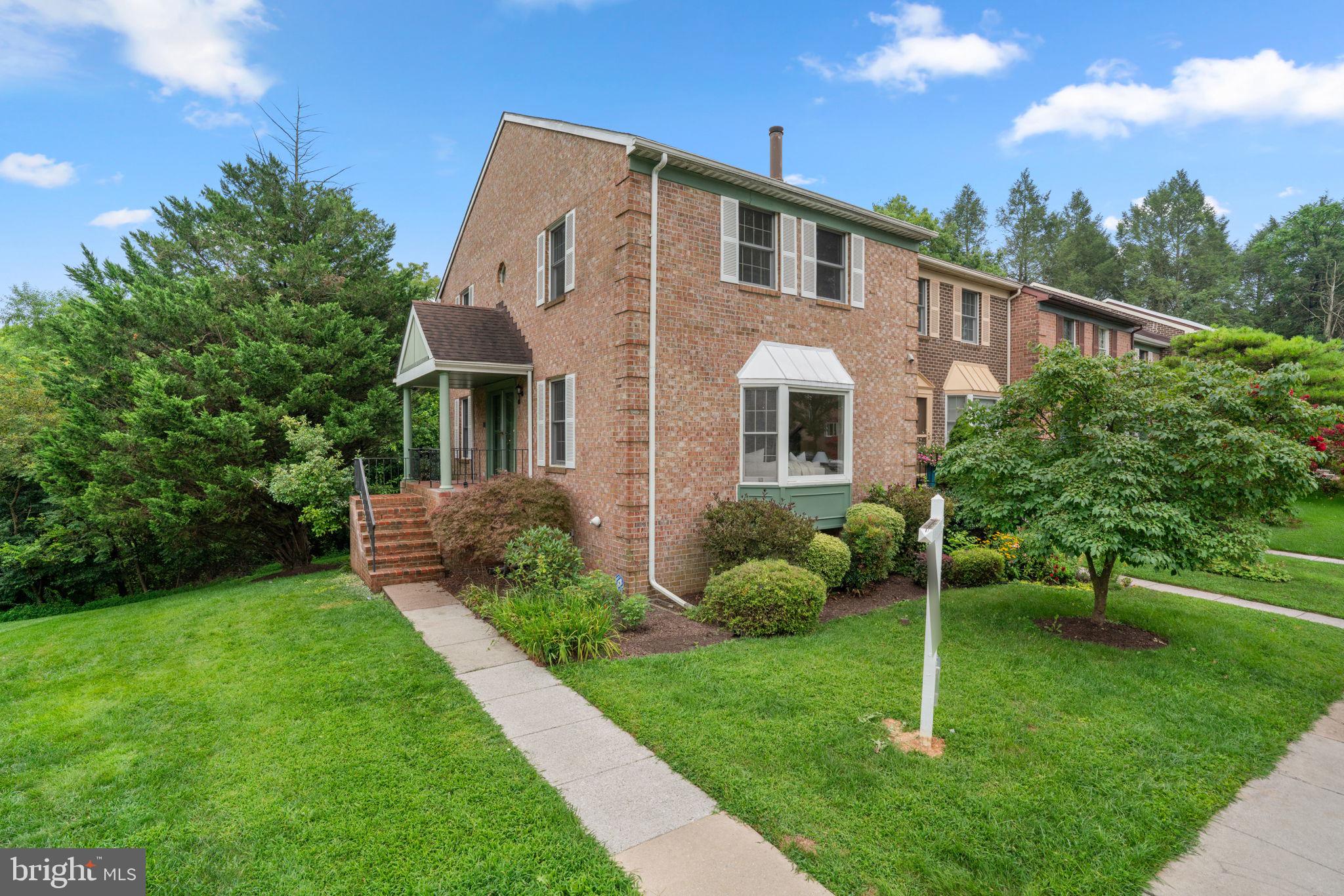 Tucked into Hunter’s Run of Hunt Valley, this 3-bedroom, 2 full/2 half bath end-of-row townhome offers extra green space, a classic brick façade, and a welcoming covered porch that invites you in—plus the ease of two assigned parking spaces. Inside, a spacious foyer opens into a sunken living room filled with natural light from the bay window. Plush carpeting and a wood-burning fireplace add warmth and comfort, especially during Maryland winters. Just beyond, the formal dining room features elegant chair rail molding and opens to the back deck—perfect for easy entertaining and enjoying tranquil views. The eat-in kitchen offers olive-toned cabinetry, a cozy breakfast nook by the bay window, and a convenient half bath to round out the main level. Upstairs, you'll find three generously sized bedrooms, including a primary suite with a large closet and private ensuite bath with dual vanities. A second full bath with blue subway tile serves the additional bedrooms. The finished lower level adds more versatility, with a family room, half bath, storage space, laundry area, and walkout access to the backyard. Hunter’s Run is nestled near the quiet beauty of the northern branch of Loch Raven Reservoir, yet just minutes from a variety of shops, restaurants, and entertainment. Just a few hundred yards from your door, the Torrey C. Brown Rail Trail offers 20 scenic miles for hiking, jogging, biking, horseback riding, and even fishing!