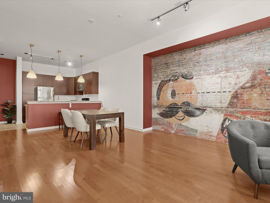 ***The Open House scheduled for 6/14 has been cancelled due to road work at the  Charles Street Promenade, it will be rescheduled for a later date. We apologize for any inconvenience, but the roadways will be shut down. Contact the listing agent if you have questions.*** 
Welcome to this amazing, large,  one-bedroom, one-bath home in the highly desirable secured entry, Twelve 09 condominium community, offering the convenience of single-level living with an urban vibe in an inviting setting. Step into the charm and uniqueness of this Baltimore condo, featuring a stunning focal point: an exposed brick wall adorned with a historic Natty Boh mural. This distinctive feature infuses the space with local character and a touch of nostalgia, creating a perfect blend of contemporary living and historic charm. The high ceilings and ceramic tile flooring guide you to the gourmet-inspired kitchen boasting stainless-steel appliances, granite counters, double sink with newer touchless faucet, pantry, and breakfast bar with pendant lighting. Step seamlessly onto the rich, engineered hardwood floor and experience the gracious openness of the sundrenched living area, presenting two alcoves perfect for placing a desk.  Peaceful slumbers are assured in the expansive primary bedroom suite adorned with soft carpeting, double closets, and a dual-entry en suite bath highlighted by a ceramic tile surround tub shower. The convenience continues with the in-unit laundry area featuring a new, full-size washer and dryer, an exterior storage unit, a personal parking space in the garage, and a community fitness center. Stay close to nature in the private courtyard, where fresh air and greenery thrive.  Indulge in the myriad attractions of this area, including the renowned Walters Art Museum, the iconic Washington Monument in the heart of Mount Vernon, and the area's captivating 19th-century architecture. With an array of dining options, cafes, and a plethora of shopping choices, the neighborhood presents a tapestry of experiences. Getting around is a breeze with close proximity to major routes such as I-83, I-395, and MD-Rt. 40. For alternative transportation, enjoy the convenience of the MARC Train, Amtrak services, and biking options. Don't wait—take the chance to make this remarkable, freshly painted gem your own, as it's sure to attract swift interest.