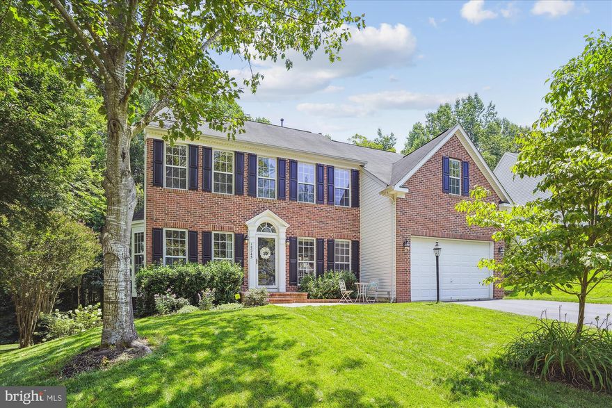 This brick front home SCREAMS elegance!  Almost 4000 Finished Square Feet, grand open floor plan, beautiful finishes throughout.  Gorgeous hardwood floors throughout the main level.  The Main level features a LIving Room, Dining room with a stunning chandelier, powder room, private office, and spacious family room with gas fireplace that is open to the kitchen.  The updated kitchen features a center island, striking granite counters, stainless steel appliances, an under-counter wine-fridge, and a large bump out to use as a seating area or large dining space.  This light-flooded room is also open to the low-maintenance, deck with low-maintenance vinyl railing that overlooks the private, fully-fenced, tree-lined yard.  Upstairs you'll find 4 bedrooms and 2 full baths.  The master suite is plenty large for your largest bedroom furniture.  The decorative tray ceiling adds a touch of style, and all the windows bring in plenty of natural light.  The primary suite also features a large attached bath and walk-in closet.  The walk-out lower level  has plenty of finished flex space and a large unfinished storage area.    (Cabinets convey, metal shelves do not).  Appreciate everything Ashland has to offer with a pool, fitness center, sports courts, playground, and more. Located in the TRIFECTA school district: Ashland, Benton, and Forest Park! Easy access to multiple commuting options and loads of bike/hike trails in Prince William Forest Park directly across from Ashland. Special financing is available through Project My Home to save you money on closing costs. Home is currently enrolled in a premium home warranty with the option to transfer to buyer at closing.