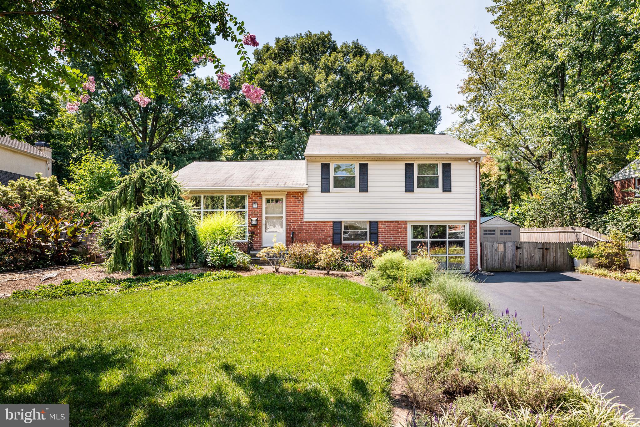 Check all the boxes on your wish-list, and more, with this move in-ready 3 bedroom, plus home office, single family home that’s just a few blocks from downtown Narberth. The first thing you’ll notice is the beauty of the home's landscape, especially the incredible backyard oasis, with gorgeous mature plantings, raised beds and perennial gardens, winding pathways and hardscaping. Inside this light-filled home you’ll find a living room with wood parquet floors, a gas fireplace, and an oversized grid picture window spanning much of the front wall. Off the living room is a formal dining area, and a modern kitchen with stainless steel appliances. Large glass doors lead to one of the home’s highlights: an amazing large sunroom room addition overlooking the beautiful private backyard gardens, which can be used much of the year thanks to a mini split system that provides heat and air conditioning. Upstairs, there’s a primary bedroom with an updated en suite bath, two additional bedrooms, and a hall bath with modern vanity and linen closet. A hall closet provides access to the attic area with lots of storage space. Downstairs, there’s a TV room/den, a separate private home office with striking floor-to-ceiling windows, a powder room, and large laundry area with utility sink and a walk-out exit to the side of the house. If your family ever needs more room, the home can easily be expanded to your custom needs. Best of all, the home is located on a quiet cul-de-sac street in a wonderful tree-lined Merion Station neighborhood, a short walk from Narberth’s downtown and train station in one direction, and the award-winning Merion Elementary in the other. It might be the perfect location, with its walkability, easy commutes, and amazing school district, all minutes from downtown Philadelphia.