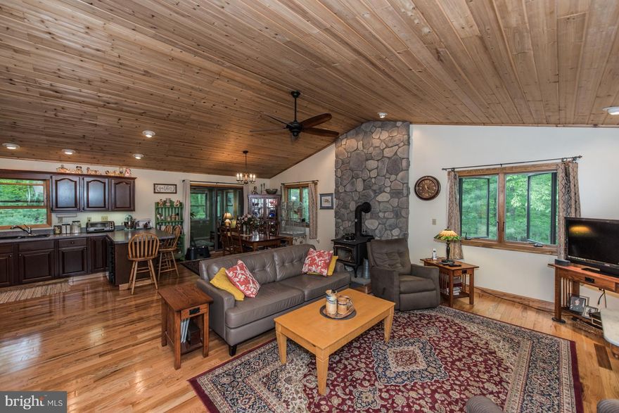 Cedar sided home on a wooded 5.78 acre lot, Short distance to the common area on the Cacapon River.  Tongue and Groove ceiling in kitchen, living and dining areas. 3 bedrooms upstairs, 2 extra rooms downstairs, finished basement w/ barn wood ceiling. The covered front porch welcomes you into the house.  Nice sun room off the dinning room. This house offers:  2018 hot water heater, 2018 heat pump, 2017 12x26 shed, 2017 3 season room, 2017 chimney cap installed, 2017 gutter guards, 2016 new fencing, 2016 whole house generator w/ 2 year mainenance agreement which can be extended, 2016 new kitchen appliances including refrigerator, propane stove and dishwasher.  A must see when looking for a well maintained house close to the Cacapon River.  Home Warranty Included.