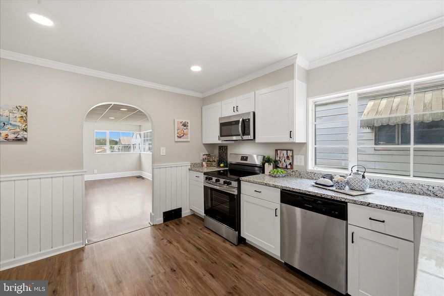 Beautiful arched doorways, distinctive corner windows, and hardwood floors throughout give this midcentury modern home a memorable sense of character. The interior balances original style with fresh updates, including a brand new kitchen with hardwood floors, granite counters, and all new cabinetry, plus updated fixtures, walls, paint, flooring, and a brand new heat pump. A bright four-season sunporch adds valuable flex space at the rear of the home and includes a large laundry area. Downstairs, the clean unfinished basement is ready for a workshop, second living area, 3rd bedroom, or storage, with a full bathroom rough-in already in place. A separate shed for storage, front stoop, and driveway parking complete the property in a convenient Martinsburg location on a corner lot.