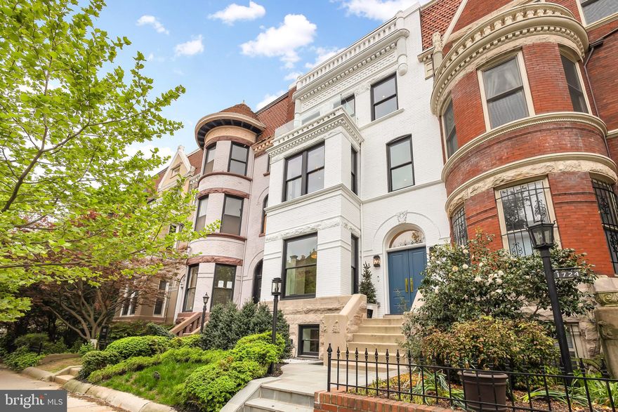 Welcome to the epitome of Washington luxury in this grand Victorian rowhome by District495 Properties. Expertly redesigned in 2023, it is where timelessness meets modern sophistication. Perfectly located along one of Dupont Circle's most famous tree-lined streets, this magnificent 6 Bedroom, 4.5 Bathroom residence spans over 3,400 square feet across four floors, featuring classic Victorian detailing at every turn. Beyond its historic facade, every aspect of this home has been crafted and curated according to the home's original character. Private, secure parking, lower level guest suite with separate C of O, and outdoor entertaining space in the heart of Washington. 

Entering through the bespoke French doors on the main level, guests are immediately struck by the timeless, herringbone White Oak flooring underfoot, 10.5-foot ceilings extending throughout, and floor-to-ceiling glass windows with modern black framing, flooding the spaces with natural light. Marble accents, custom millwork, designer lighting, and premier fixtures by Waterworks tastefully complement the home’s classic design. No detail was spared in the redesign of this home. Discerning buyers will notice nuances such as the color of the stairwell balusters curated to match the window framing and fixtures. The gourmet kitchen, featuring custom cabinetry, an ILVE Majestic stove, Thermador appliances, and a ceramic Shaws sink, is a haven for culinary enthusiasts and hosts alike. Lacquered brass finishes complete the design of the kitchen and seamlessly extend into the powder room. Blond oaks and black finishes extend throughout the home, with classic polished metal fixtures finishing the bathrooms. Professional landscaping in the front and rear yards only add to the property's upscale appeal.

The second level is dedicated entirely to the primary suite, complete with a separate office, sitting area, and an expansive dressing suite featuring custom-built cabinetry. The primary bathroom is an indulgence in and of itself, with Waterworks classic polished nickel fixtures, dual vanity sinks, a lavish soaking tub set against an elevated gas fireplace, and a separate, dual rainfall shower.

Ascending to the homes highest level, guests find 3 additional bedrooms and 2 full bathrooms, one ensuite, providing ample space and privacy for family or guests. The lower level of this home, complete with its own Certificate of Occupancy, offers versatility with a full kitchen and separate front and rear entrances, ideal for family gatherings or potential rental income, enhancing the home’s investment appeal.

Outside, the professionally landscaped back patio and yard offers an idyllic retreat for relaxation or entertaining. Enjoy the convenience of two secure parking spaces, each with its own EV charger, along with additional parking behind a roll-up door.

This home is outfitted with every amenity for entertaining, including 3 sets of washers and dryers and integrated audio speakers throughout, ensuring no detail is overlooked in this unparalleled oasis of luxury living.