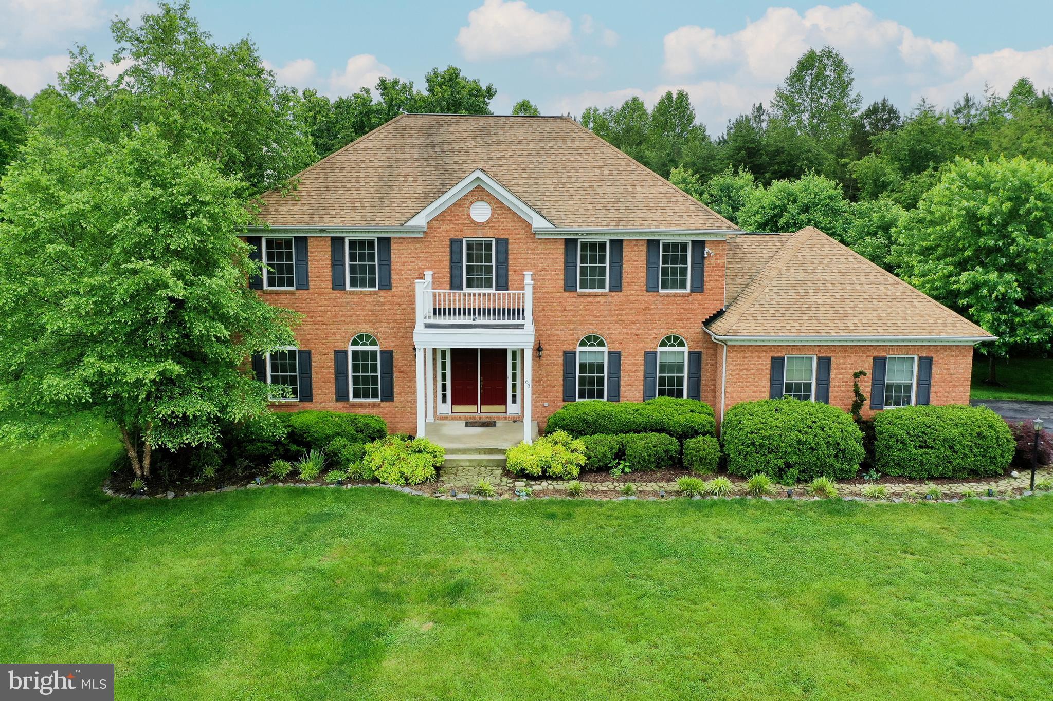 A stunning classic at Lake Anna, Virginia. This beautiful brick front home includes a deeded boat slip (#E14) and is located in the most desirable subdivision on the private side of the lake: The Waters at Lake Anna. With fantastic amenities like a community pool, clubhouse, tennis and pickleball courts, a sandy beach, boat ramp, and more, this neighborhood offers the best when it comes to the lake lifestyle. High-speed fiber internet available! New carpet and paint throughout. Over 3,800+ square feet, 4 bedrooms and 3.5 baths. Luxury Vinyl Plank flooring, crown molding, chair rail and a gas fireplace. The kitchen was renovated in 2022 with all new cabinetry, stainless steel appliances, granite counters, center island and a 6 burner gas stove. The primary suite features a garden tub, separate shower, double vanity sink, and a walk-in closet. There are 3 additional bedrooms on the second level. Your family and guests will enjoy spreading out in the lower level basement with a family room, rec area, wet bar and full bath. Enjoy your morning coffee from your sunroom or relax and entertain on your composite back deck or patio. You will also love the 4-6 person hot tub that conveys! The invisible fence will also give you peace of mind for those fur babies! Beautifully landscaped yard, a paved driveway and a 2 car attached garage complete this beauty. Fantastic location and just a 5-10 minute drive to groceries, restaurants, ABC, nail salon, vet clinic, Lake Anna Taphouse, coffee, The Yacht Club and more!