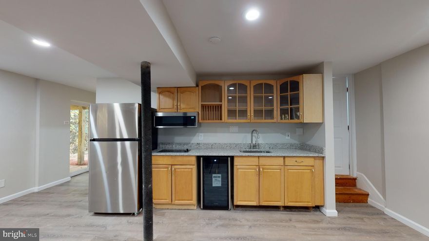 Gorgeous 1 Bedroom 1 Bath Basement Rental is a completely renovated space boasting new granite countertops,  and all new stainless steel appliances grace this huge space.  The Living Room/dining room space is roomy and features a wood burning fireplace as well as leads to a large patio for outside space facing a beautiful forest behind the home.  The bathroom is all new featuring a large stand in shower.    The bedroom is spacious with a large closet and gorgeous wide plank flooring.   A new walk way has been created for private access to your space.  The laundry area is shared amongst tenants.