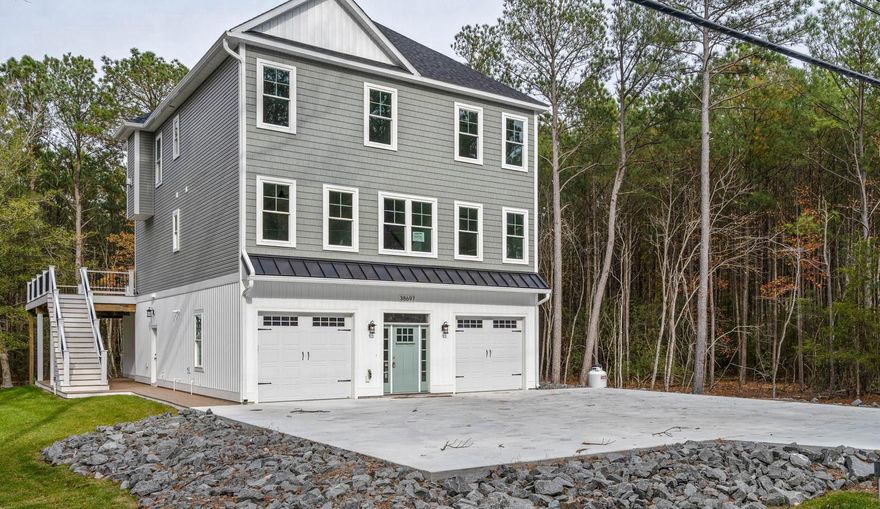 This beautiful coastal home is situated on an oversized wooded lot, located just minutes from downtown Bethany Beach and a short distance to the sand.  Access the spacious upper level by elevator. Here you will find a beautifully designed kitchen, featuring stainless appliances, gas fireplace, large screen porch, primary suite and guest bedroom and bathroom with custom tile and upgraded counter tops. Sit and enjoy the outdoors and the beautiful scenery this lot has to offer on the expansive deck located on the second floor.  Just inside you will find a wet bar complete with a refrigerator and microwave for entertaining guests, 3 additional bedrooms and 2.5 baths and a large laundry room with washer and dryer round out this floor. On the lower level you have a large game room / flex room with a full bath. This allows you ample space for additional sleeping if needed. Pilings for a future pool have already been put into place under the expansive deck. Tax information is based on undeveloped land and does not reflect true annual tax fees. Even though they are not pictured all walk-in showers have glass doors.