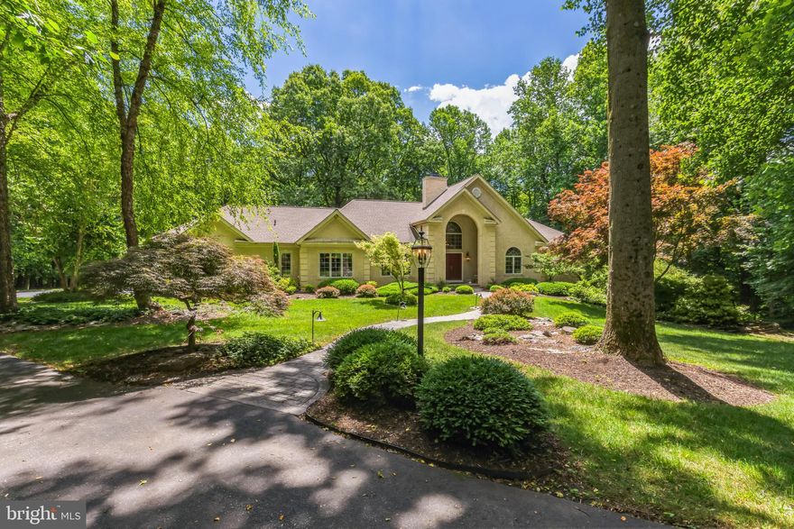 Location, lifestyle…community! Chester County at its best boasting quiet grandeur with custom upgrades throughout. 1425 Carolina Place is located in the sought after community of Virginia Glen, a subdivision of Brandywine Ridge. Residing on 8.9 acres down a private drive in the Downingtown Area School District and US News and World report rated #2 in Pa STEM school. Nearly 3400 square feet of custom detailed luxury all on one level! This three bedroom with four bathroom home offers architectural design at every turn. High end light fixtures, master carpentry woodwork and custom hardware throughout worth thousands in upgrades for the discerning buyer! The winding walkway is accented by natures beauty of stone and custom landscape along with outdoor lighting welcoming you to a two story ached portico. Step in through an oversized double door entryway with soaring ceilings graced with an elegant multi-tiered chandelier and marble flooring. The open formal living and dining rooms adorned with custom pillars, chandeliers, sconces and hardwood floors offer a special place to enjoy friends and family and those special occasions. An arched hallway brings you past the formal powder room with a custom pedestal sink accented with 14k gold and custom brass fixtures like no other! The heart of the homes oversized kitchen offers custom hardwood 42’ cabinetry, granite countertops, stainless steel appliances, tiled backsplash and island with a bonus wall of custom cabinetry to display special pottery pieces and books to relax and enjoy. As well a walk-in pantry with custom built-in shelving and drawers one would only but expect! There is also the second powder room and laundry area with access to the oversized three car garage. The additional screened in three season porch and deck provide added living space to entertain and enjoy the private yard in the rear of the home. Gather in the two story oversized family great room where a wall of master carpentry bookcases will take your breath away! Showcasing ones love for travel, special memories and books for you to embrace all while enjoying a floor to ceiling stone, gas burning fireplace… this room is magnificent! There are three bedrooms. Two bedrooms share a Jack and Jill bath with separate vanities with custom brass and crystal hardware. Custom built-in closets with encasement windows offer an abundance of natural light and privacy. The primary bedroom offers a tray ceiling with two walk-in custom closets and an oversized primary bathroom. The Jacuzzi soaking tub detailed with  travertine tiles, shower stall and dual vanities with custom brass hardware offers a spa-like get away! There is a full size walk out unfinished lower level to make your own or use for storage. Natural stone retaining walls and terraces surround the exterior of the home with a vast amount of yard surrounded by trees for privacy… this is everything one could want and more! Located near the Downingtown train station, Rt 322, Rt 30 and Rt 202. Wonderful restaurants, shopping and walking trails…Opportunity Awaits!