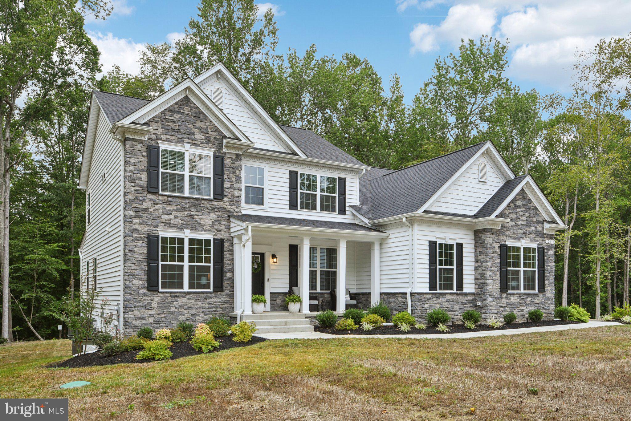 Welcome to 12130 Calverts Run Ct, an elegant stone-front Fairfax model gracefully set on a 1.29-acre private lot in the prestigious community of Fischer’s Grant. Built in 2024, this residence offers over 4,300 sq. ft. of beautifully finished living space, blending timeless design with modern convenience and upscale finishes.
The main level features an open, light-filled layout perfect for everyday living and entertaining. At the heart of the home, the gourmet kitchen shines with quartz countertops, a large center island, stainless steel appliances, and a sunlit breakfast area that flows seamlessly into the family room with its coffered ceiling and gas fireplace. A formal dining room and private study provide flexible spaces for work or gatherings. One of the home’s standout features is the bump-out extension, thoughtfully designed to create a spacious main-level in-law/guest suite with a walk-in closet and full bath, ideal for multi-generational living or long-term guests.
Upstairs, the luxurious owner’s suite serves as a private retreat, offering a sitting area, spa-inspired bath with soaking tub, oversized walk-in shower, dual vanities, and expansive walk-in closets. Three additional bedrooms share a well-appointed hallway bath, while a versatile flex room provides the perfect option for a second laundry, exercise room, hobby space, or extra storage.
The finished walk-out basement extends the living space with a large recreation room, full bath, generous storage, and a private room that can be used as a bedroom, offering comfort and flexibility for family or visitors.
Outdoors, enjoy a serene backyard retreat with a full irrigation system (front and back), a whole-house water filtration system, upgraded well capacity, professional landscaping with front and side lighting, and more.
Located just minutes from shopping, dining, schools, and commuter routes to DC, VA, and Waldorf, this home provides both convenience and the tranquility of an established neighborhood.
12130 Calverts Run Ct is more than a home; it’s a lifestyle. Move-in ready, it combines luxury, efficiency, and versatility in one exceptional package.