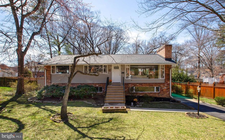 Buyer financing issues. Charming Mid-Century Rambler with incredible light!  Hardwood floors throughout main level.  Living room with large picture window and wood-burning fireplace. Dining room french door leads to deck.  Tall white cabinets in Kitchen, gas cooking, pantry, and pass through to dining room. Bright Master bedroom with full bath, walk-in closet, and french door to deck. Huge Family Room in lower level with brick hearth ready for entertaining. Walk out basement to covered patio and flat backyard. Super storage area, 2nd pantry, and laundry. Bedrooms in lower level are Dens. Super location, within walking distance to shops, grocery store, and restaurants. Updates: Roof(2015), driveway(2015), hot water heater(2013), front door(2019), some windows, and freshly painted.  *Seller offering $10K towards deck and older windows, these items sold As-is.