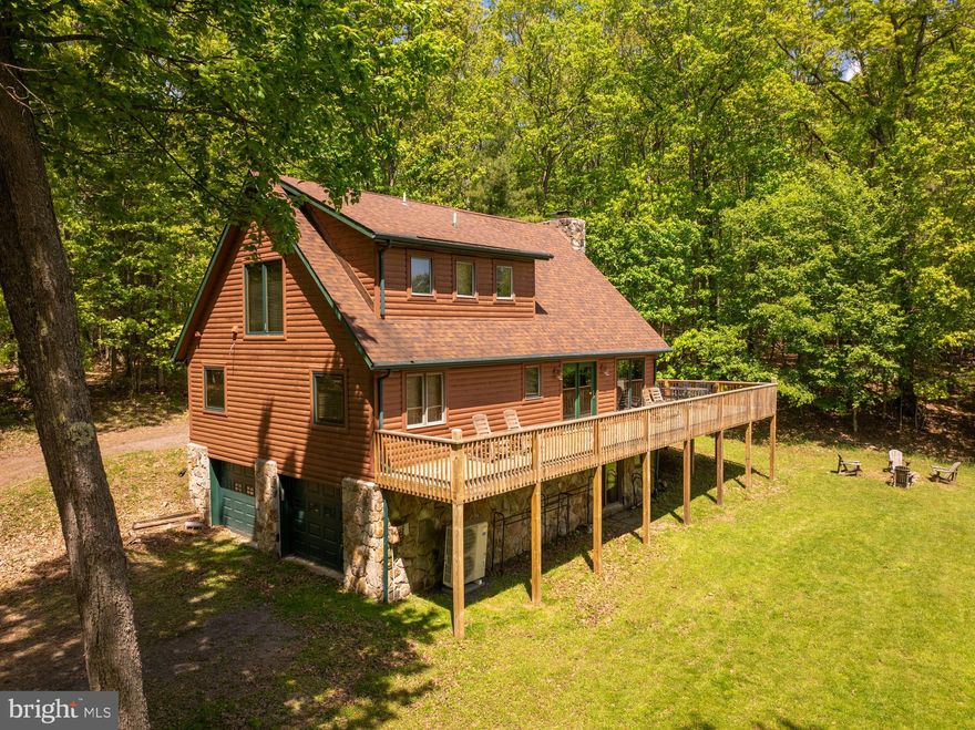 Beautifully renovated lake access log home located in the centrally located Paradise Cove community. This home offers three levels of living space, an open floorplan and three bedrooms. Recent upgrades in the past five years which include renovated kitchen,  granite countertops, upgraded baths and floors, new wrap around deck, some new windows, new appliances, new roof, and new garage doors and newly stained log siding costing over $200k. The large windows allow you to enjoy views of Deep Creek Lake from almost any room. The outside area is just as pleasing with a wrap-around deck, hot tub, and firepit. With 1.26 acres and 1/9 interest in the 29 adjacent acres to the rear, there are many recreational opportunities right out your back door – biking,  ATV, snowmobile, sled, or hike. If all of this isn't enough, take a short walk to your dock slip to enjoy everything Deep Creek Lake has to offer. Also includes a 1/8 interest in the common area by the lake. Call today to preview this great property!