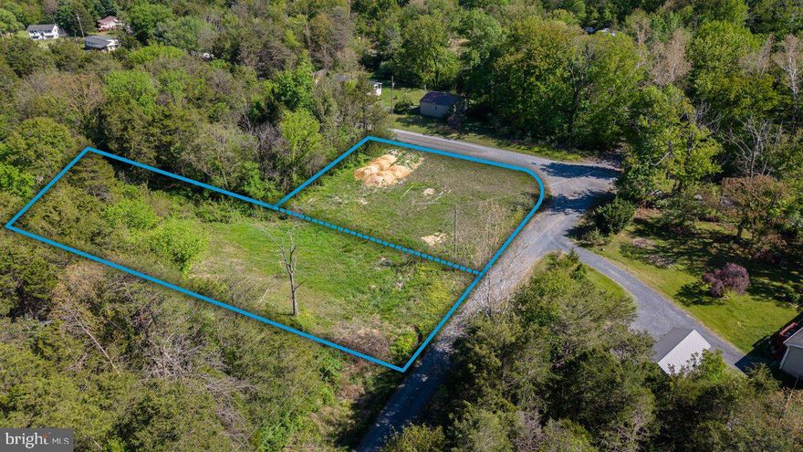Nestled in the secluded and well-maintained Land of Luray subdivision, this unique property combines two lots to create a spacious and private 0.97-acre setting perfect for building your dream home. The land is partially cleared and has already been IMPROVED with 10 loads of topsoil, offering a great head start for construction, and WELL AND SEPTIC PERMITS are already on file to make the process even easier! Enjoy the peace and privacy of this tucked-away location while still being just 10 minutes from restaurants, grocery stores, and everyday conveniences, all within two hours of Washington, DC and Northern Virginia, making it an ideal spot for a full-time residence or a relaxing weekend retreat!