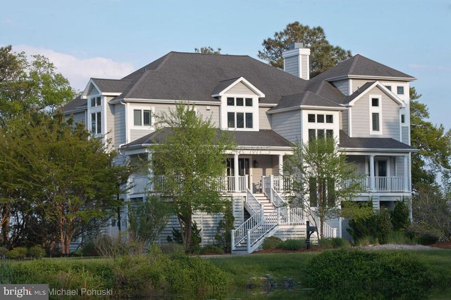 Custom designed waterfront home with only the best of appointments and finishes awaits you.  This home is located in the lovely waterfront community of Ocean Reef in the West Ocean City area. Privacy and comfort abound, yet you are only minutes to the beach and Ocean City. Spectacular views of Sinepuxtent Bay, Assateaque Island, wildlife and the Atlantic Ocean create the picture perfect setting.  Walk out your back door to you pier and dock with private boat lift.  There is ample space for an outdoor pool & outdoor dining area.  Renderings for your future outdoor oasis are available online.When approaching this magnificent home you will be greeted with a circular driveway in a serene environment.