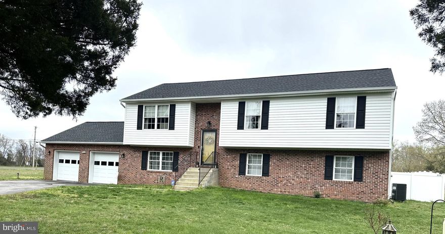 Beautiful Split Foyer located very near to the entrance of Longview Beach Community. The Longview Beach Community features a boat launch, newly renovated fishing pier, play ground, basket ball, and tennis court. The home features 3 bedrooms on the main level and 3 bathrooms (1 full bath with jetted tub with shower in the basement). Recreation Room in the basement with auxiliary room between Recreation Room and 2 car garage. Access to the 2 car garage is from auxiliary room by a door. The garage inside walls are covered with sheet rock and insulated. Rear access from auxiliary room to the back yard is by sliding glass door. The back yard is completely fenced in with a new solid vinyl fence providing for privacy with a double 8’ access gate on the left front. The new roof was completely replaced less than 1 year ago. The septic tank was pumped less than 1 year ago. To top all of these features, the seller is providing a home warranty via HSA to the buyer at settlement!