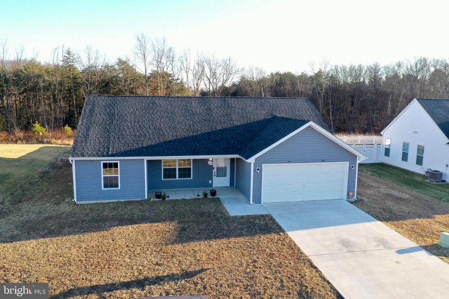 Like-new 3 bedroom, 2 full bath ranch built in 2022 offering 1,564 finished square feet of open, modern living space. This home features a desirable split-bedroom floor plan, spacious living area with electric fireplace, and a bright sunroom off the rear of the home that overlooks the backyard.

The kitchen is designed for both everyday living and entertaining with granite countertops, stainless steel appliances, white cabinetry, and a center island with additional seating. Durable PVC flooring runs through the main living areas with carpet in the bedrooms for added comfort.

The primary bedroom offers a private retreat with attached full bath and double vanity. Two additional bedrooms and a second full bath provide flexible space for guests, home office, or family needs.

Situated on a .24 acre lot, the backyard is fully enclosed with a privacy wood fence, offering great space for pets, play, or relaxing evenings. Additional features include a 400 sq ft two-car garage and HOA-maintained community.