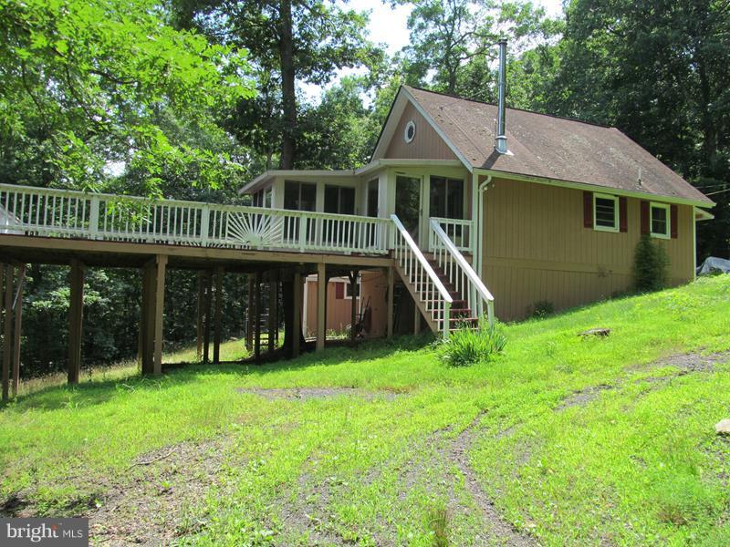Immaculate 3BR/2BA Cabin with a 22X8 Florida/Sun Room for awesome year round views, a 29X23 deck to entertain or just relax and a 16X6 Screened Porch. In 2014 all appliances were replaced, bathrooms were redone, new cabinets put in and new carpet & flooring was installed. The home has plenty of storage space inside and a shed outside. All appliances convey. It's ready and waiting for you!