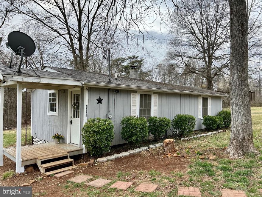 GREAT NEW PRICE!!  Cabin on almost 5 acres is a one bedroom/living room combination.  Decent sized kitchen with room for a dining table. Brand new stove, refrigerator, and carpeting.  Freshly painted, has washer & dryer.  This tiny gem is all about location, location...with acreage!  Live in while you build a home, or use as a weekend getaway.  Was originally a hunting cabin, current owner installed well & septic, cabinets, laminate flooring.  Good also for use as a rental.