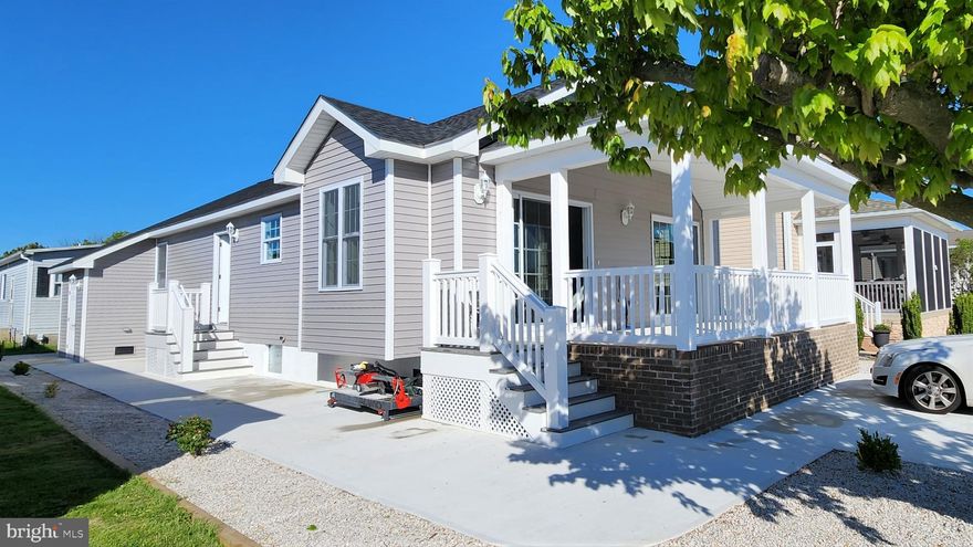 NEW CONSTRUCTION! This custom built home is located in the Montego Bay community in North Ocean City Maryland and is situated less than 3/4 of a mile from Ocean City's beautiful 10-mile long public beach and within walking distance to the busline, the Montego Bay Shopping Center, many restaurants & bars and the 58-acre Northside Park. The home features a 10' x 20' front porch with a cement floor & cathedral ceilings, an open floorplan with a living/kitchen/dining room combination, cathedral ceilings-both in the great room & master bedroom, granite counter-tops, a kitchen island with a granite top, stainless steel appliances, ceramic kitchen backsplash, a laundry room with a full size side by side washer & dryer, a master bath featuring a walk-in shower with floor to ceiling tile shower walls & tile flooring , ceramic tile shower walls in the guest bath, a sprinkler system, crown & baseboard moldings in the bedrooms, baths, laundry room and hallway, luxury vinyl plank flooring,  2 x 6 wall construction, 4 ceiling fans with lights, bedroom closet lights, a floored attic, a bump out in the living room for a gas fireplace, a window seat in the living room and extra large windows & two 6' wide sliders in the living area for abundance of natural light. Outside features a landscaped lot with no grass to cut, a large cement patio, a 5' x 10' custom-built storage shed, with high ceilings and drywall interior and a new 2-car cement parking pad. The community features 3 pools (including a kiddie pool for the little ones), 2 tennis courts, a 9-hole miniature golf course, a shuffleboard court, a bayfront boardwalk with 3 fishing piers, a canalfront fishing & crabbing area, an 8-acre wildlife sanctuary/pond with a 1/2 mile paved walking path, a 5-acre open park and street lighting with a lamppost at every residence. Additional amenities include city streets & sidewalks, city water & sewer and city trash collection. The HOA fees are just $396 a year!