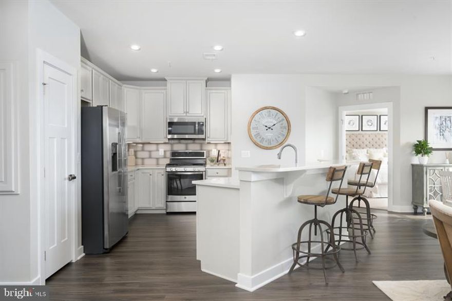 Welcome to Urbana's only EXCLUSIVE 55+ active adult elevator condo's community!  This to be built Chambord at the Woodlands by Ryan Homes.   Embrace the convenience of a condo with all the comforts of home! Enjoy your own private 1 car garage & driveway, 1-level living with open design, gourmet kitchen w/ 2-tier island, private covered porch, panoramic views in primary suite, and so much more! Built with upgraded 5 inch  engineered hardwood, luxury tile, granite in kitchen and both baths,  42 inch kitchen cabinets. Community features endless amenities   truly resort-style living!  Other floor plans and homesites are available. Photos are representative.