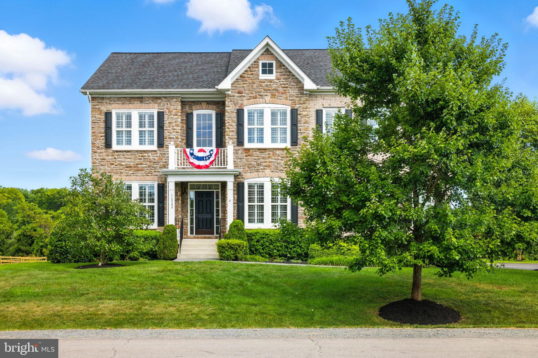 Experience refined living in the beautiful Raspberry Falls neighborhood with this elegant Colonial-style residence, perfectly positioned near the 12th hole of the award-winning Raspberry Falls Golf Course. Built by Van Metre in 2012 and elegantly enhanced with over $250K in updates by the current owners, this home offers an ideal combination of timeless style, modern upgrades, and everyday comfort.
Inside, rich 5-inch wide hardwood floors, detailed crown molding, and an open, light-filled layout set the tone for both relaxed living and elegant entertaining. The gourmet kitchen features premium countertops, stainless steel appliances, a six-burner gas range, and a spacious center island—perfect for gatherings large or small.
The main level also includes a formal dining room and a welcoming living area centered around a striking stone gas fireplace. Expansive windows fill the home with natural light and frame scenic views - and most of these windows are adorned with timeless plantation shutters.
Upstairs, the primary suite offers two walk-in closets and a spa-like bath with a soaking tub and walk-in shower, with a new frameless glass door. Three additional upstairs bedrooms provide generous space and privacy.
The fully finished walkout basement offers versatility for a home office, gym, workshop, or recreation room, and includes another legally permitted bedroom and bathroom.
Outdoors, enjoy a 0.56-acre landscaped lot backing to trees and open space. Entertain on the extensive hardscape patio, relax in the hot tub, or take in serene views of the nearby creek and golf course. Evening ambiance is enhanced by outdoor lighting.
Additional features include a three-car garage, ample driveway parking (the driveway was repaved in 2024!), and access to community amenities—pool, tennis courts, and walking trails. Raspberry Falls Golf Club membership is optional.
Agent-Owned Property — Independently Appraised July 2025 at $1.4M