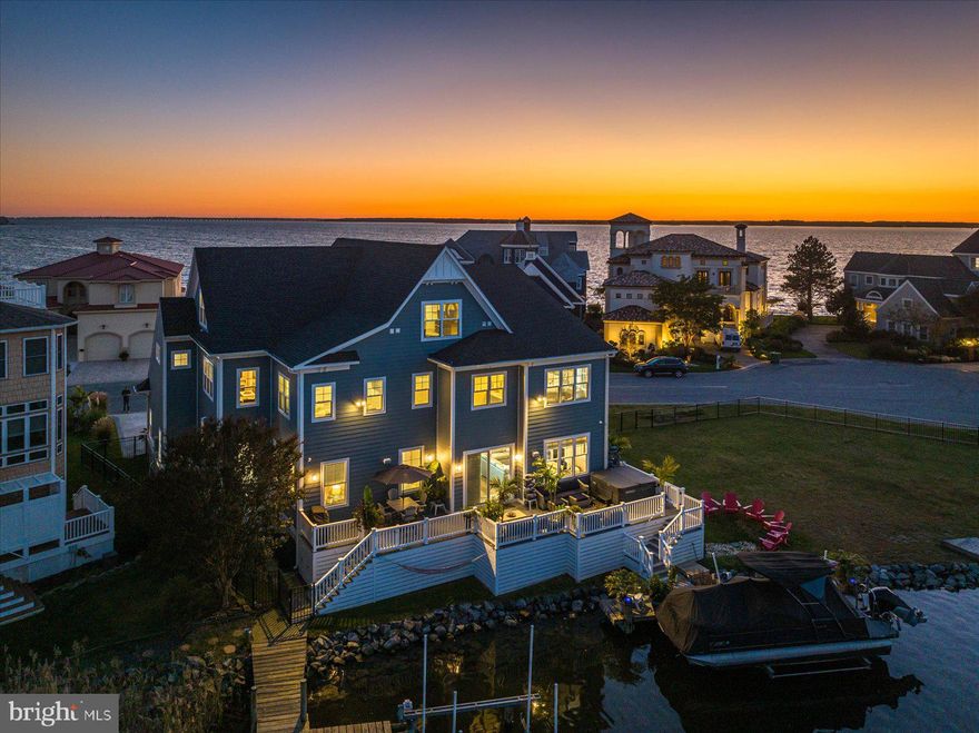 Coastal Luxury 6BR/6BA Waterfront Dream Home hits the market!  From the minute you pull up to this custom-built home you will appreciate its curb appeal and custom landscaping.  As you walk through the front door you will fall in love with the designer colors and highest quality materials used throughout the home.  This stunning home offers a kitchen sure to please the chef in your family.  The large eat-in kitchen has a center island, breakfast bar, quartz and granite countertops, Bosch and Thermador stainless steel appliances, beverage center, wet bar area and plenty of cabinets for storage.  Enjoy wonderful family gatherings and entertaining in the great room which overlooks the water. The family room is open to the dining area overlooking the water as well.  Relax, watch the sunset and have a cool summertime drink on the low maintenance deck.  There is also a first-floor office perfect for those who work remotely from home.  This home offers 2 master suites, one on the first-floor overlooking the water with a large walk-in closet and large bathroom with double vanity and shower and heated tile floors.  Directly accessible from the two-car garage, the first floor also has an oversize mud room with custom woodworking and a full bath.  Take the elevator or walk up the stairs to the second floor which offers a stunning second Master Suite with his and hers walk-in closets, an oversize master bath and a large separate sitting room. There are 3 more bedrooms and a spacious 2nd  family room on the second floor with 2 additional custom tile full baths. The third floor, also accessible with the elevator or stairs, offers another guest bedroom, exercise room with balcony, and a second home office.  Imagine yourself in this beautiful home in one of the nicest communities in Ocean City. Heron Harbour Isle is amenity rich with two outdoor pools, an indoor pool, a kiddie pool, fitness center, social room, sauna, locker room, two Har-Tru tennis courts, sidewalks and piers. Enjoy your boat, fishing, crabbing, kayaking and paddle boarding all directly out your back door. This home includes a pier and boat slip with 10,000 lb lift. This extraordinary home was designed and built by M&M Builders and Contractors, an award-winning builder with more than 34 years' experience.  This home has the quality and efficiency of Pella windows and doors throughout. There is also landscape irrigation, hot tub,  extensive outdoor lighting and fencing.   Schedule your appointment today before it's SOLD.