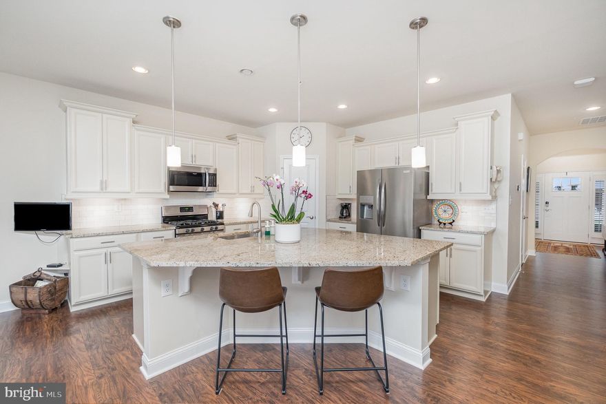 *MAJOR PRICE IMPROVEMENT! Welcome to your dream home in one of the area's most desirable gated communities of Bulle Rock. This beautifully maintained ranch-style residence offers the perfect blend of comfort, style, and functionality. Step inside to discover a spacious open-concept layout that seamlessly connects the kitchen, dining, and living areas—ideal for both entertaining and everyday living. The heart of the home features a modern kitchen with high-end finishes, abundant cabinetry, and a large island perfect for gatherings. The main level offers three generously sized bedrooms, including a luxurious primary suite complete with a spa-like bathroom, walk-in shower, vanity table and dual sinks—your own private retreat. Off the dining area, you’ll find a bright and airy all-season room, perfect for enjoying your morning coffee or relaxing with a book, no matter the weather. Step outside to a beautifully landscaped rear yard with a custom patio—a serene space to unwind or host outdoor gatherings. The finished lower level adds even more versatility, featuring a large bonus room, ideal for a home gym, 4th bedroom, media room, or office, plus ample storage space to keep everything organized. The community covers lawn care, snow and trash removal - and features a 37,000 sq ft Residents' Club with indoor and outdoor pools, tennis and pickleball courts, full gym, billiards rooms, walking trails and much more!  Don’t miss this rare opportunity to enjoy low-maintenance living in a secure, amenity-rich community. Schedule your private tour today!