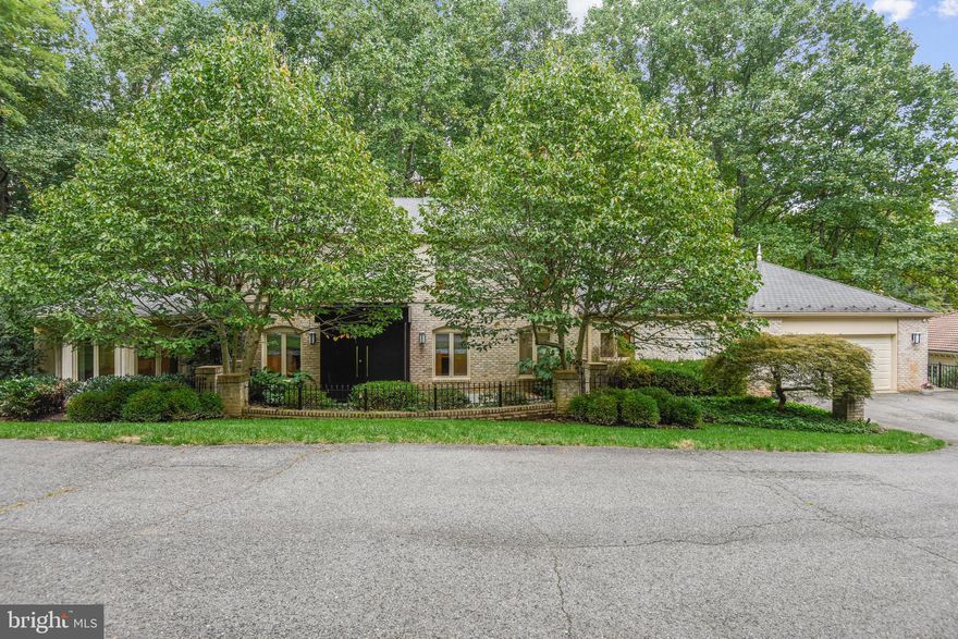 Sleek and stunning renovated custom built brick masterpiece on 1.3 acres in a terrific neighborhood. A hidden modern design with an open floor plan is revealed behind the custom front doors.  Gourmet dream kitchen with a large granite island, Subzero refrigerator, Wolf double oven & Wolf cook top, adjoins other great spaces. Five bedrooms and five and a half baths give you the option for a big family or lots of guests. Private spaces also abound including a dramatic,  isolated office perfect for quietly working at home. To-die-for master suite. The finished walk-out lower level is perfect for recreation room space where the kids can play. Be careful not to miss the secret room (yes, with secret door) presently used as a wine cellar. It is super comfortable and has a three zoned HVAC system. Tremendous storage throughout.  It is truly stunning - a fun house inside and out. The deck and views are glorious throughout the year with ever changing sights and nature. Two-car side load garage. Superior location - just walk to The Potomac School and just a 15 minute drive to Tysons Corner and Georgetown.