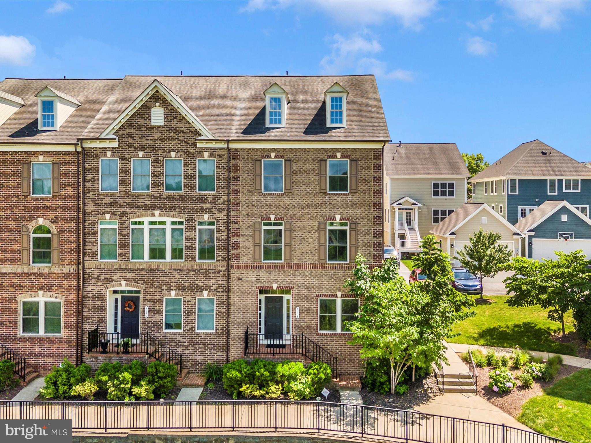 Welcome to this generously sized, four-level brick end-unit townhome, featuring four bedrooms, three full baths, and two half-baths. Experience elevated living with a private 4th level terrace and the ease of an attached two-car garage plus extra driveway parking.
As you enter on the ground level, a versatile small open room to your right offers endless possibilities – perfect for a dedicated work-from-home office, a children's playroom, a compact fitness area, or a serene reading nook. Further down the hall on this level, you'll find a convenient half bath and a small utility closet, just before accessing the two-car garage.
Step up to the main level's open floor plan, where the heart of the home resides in the spacious gourmet kitchen. This culinary haven provides abundant storage with its extensive cabinetry, stainless steel appliances (including a wall oven, built-in microwave, gas cooktop, refrigerator, and dishwasher ), and a striking granite island with dual sinks and comfortable bar seating—perfect for everyday meals or entertaining. The kitchen effortlessly transitions into the dining area and a large living room, pre-wired for your wall-mounted TV. Gleaming hardwood floors extend throughout the kitchen and dining area, and also the convenient half bath.
The third level is home to the elegant primary bedroom suite, highlighted by a tray ceiling and a spa-inspired en-suite bathroom. Indulge in the oversized shower with floor-to-ceiling tile, dual showerheads, and a sleek glass door, along with dual sinks set in granite countertops and a privacy toilet. This level also includes two additional well-proportioned bedrooms and a second full bathroom.
Unleash your creativity on the flexible fourth level. This adaptable space can serve as a fourth bedroom (or even a second primary suite with its own full bath and walk-in closet), a productive work-from-home office, a vibrant recreational area, a personal gym, or a dedicated home theater. Designed for entertaining, it features a bar with a refrigerator and seamlessly connects to your private 4th level terrace—an ideal spot for outdoor relaxation and hosting friends and family.