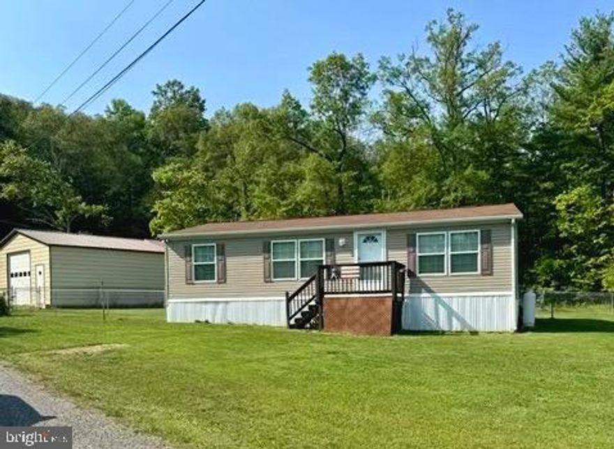 2012 28' X 40' - 3BR 2 BA well-maintained home on a quiet street right off US 522.  Convenient location to access Berkeley Springs, Winchester or I-68.   Large open Living Room/Kitchen combo with gas range, dishwasher and garbage disposal.  Primary bedroom has a spacious walk-in closet and attached bathroom.  Large 12' x 16' covered rear deck with ramp access to fenced in rear yard.  26' x 25' detached garage (less than 5 years old) with concrete floor, high ceilings and electric opener for the 10' door!  Plenty of extra storage with three additional sheds all with electric!  Two 12' x 16' and one 8' x 10' which is supplied with electric heat and houses the well pump, UV filtration and water treatment equipment all serviced.