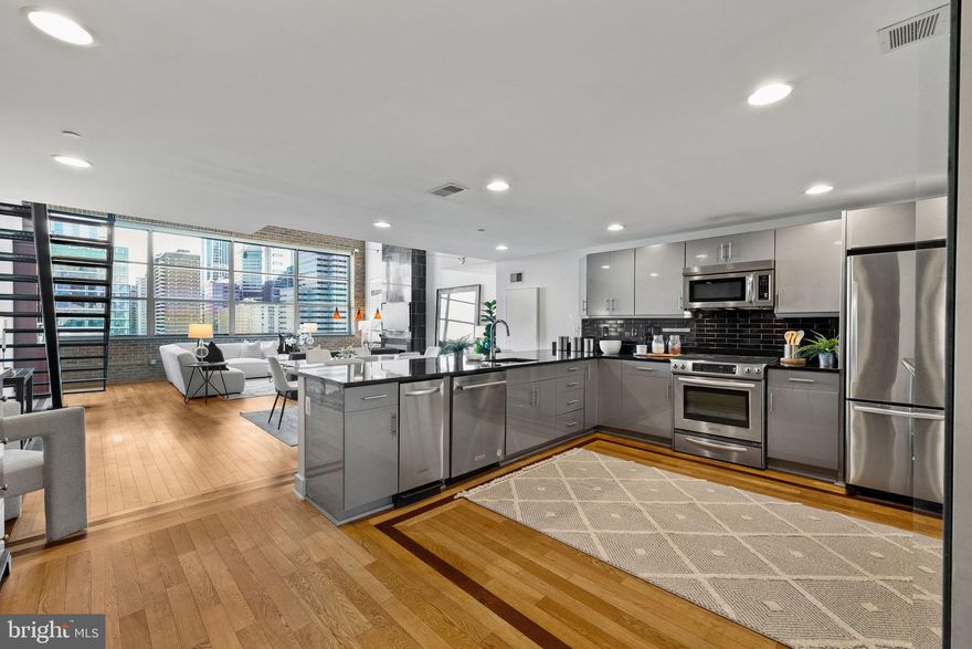 THE VIEW BELONGS TO YOU! - Enjoy breathtaking, sweeping skyline views from this sprawling  three bedroom, two bath PENTHOUSE residence with private ROOF DECK and TWO CAR* GARAGE PARKING. Spanning over 2,100 square feet of stunning living space, this home features one of the most coveted penthouse floorplans in the building. The living and dining areas boast dramatic ceiling heights, gleaming hardwood floors, and a wall of windows that flood the space with an abundance of natural light. The chef’s kitchen with oversized breakfast bar showcases stainless steel appliances, sleek cabinetry, and designer fixtures. The private roof deck is generously sized and features a pergola, storage closet, and jacuzzi tub, along with custom dining and seating areas ideal for al fresco meals, barbecues, entertaining, or simply relaxing above the city. The primary bedroom suite offers ample  closet space and a lavish bathroom with double sinks, an oversized walk-in shower, and a separate soaking tub. The additional two bedrooms are well-proportioned and feature custom closets. On-site garage parking, a 24-hour concierge, and a state-of-the-art fitness center complete this dramatic loft-style penthouse in the sky. Perfectly located at The Larkin at 2200 Arch, this one-of-a-kind residence is steps from fine dining, world-class shopping, renowned cultural destinations, and vibrant nightlife. Convenient to Trader Joe’s, 30th Street Station, the University of Pennsylvania, Drexel University, HUP, CHOP, and all major public transit lines.