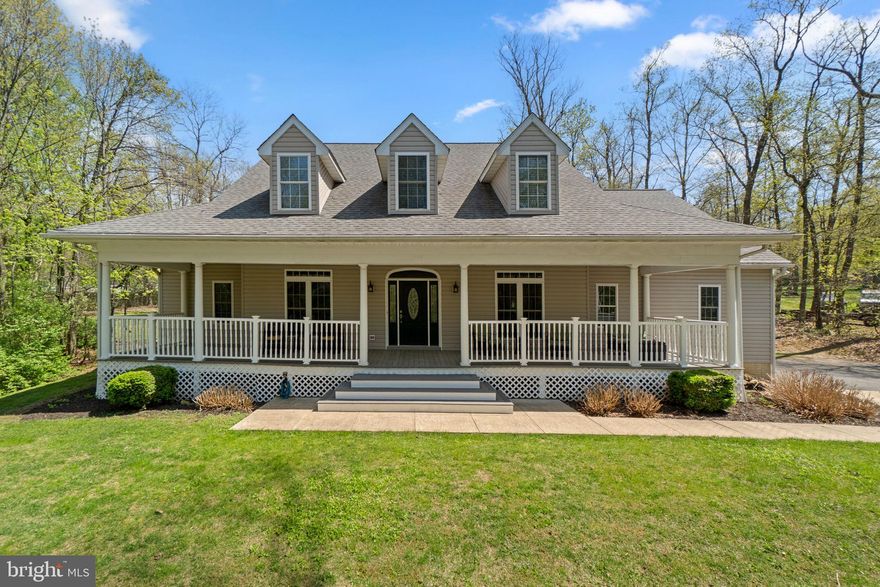 Set beyond a charming frog pond and a sweeping wraparound porch, this one-of-a-kind property sits on 1.69 acres of scenic beauty, where mornings start with views of nature and evenings unwind in privacy-- all just minutes from major commuter routes. Its the rare kind of home that feels like a peaceful escape without sacrificing everyday convenience. Step inside to a breathtaking grand foyer with a statement staircase that opens into a bright, airy two-story family room, creating a dramatic yet inviting space perfect for everyday living and entertaining. Fresh paint and gorgeous hardwoods are highlighted throughout the home, and every detail was thoughtfully considered. The main level features a dedicated office/library with built-in bookcases and French Doors for privacy. A formal dining room and a spacious gourmet, eat-in kitchen with a wet bar, island, and dining area are perfect for entertaining! The kitchen flows seamlessly into the stunning family room with vaulted ceilings and wood-burning fireplace. Off the kitchen, a powder room and laundry room/mudroom with sink and plenty of cabinetry round out the right wing of the home. A second powder room exists on the left wing of the home. Escape to the expansive main level primary suite-- a true retreat, offering a spa-inspired ensuite with a dual shower head steam shower, jetted soaking tub, dual vanities, and a large walk-in closet with organization system. Upstairs, youll find three spacious bedrooms, each with charming dormers, private ensuite bathrooms, and generous closet space, plus an expansive bonus room with a skylight and Palladian window-- a space ideal for recreation, gym, or a guest retreat. The open overlook to the family room adds architectural interest and connectivity throughout the home. The enormous basement with walk-up outside access is designed for entertaining and unforgettable evenings, featuring a wet bar with large island, a full bathroom, abundant storage, and the best part-- a one-of-a-kind hidden speakeasy concealed behind a bookcase. An unforgettable focal point! Step outside to a fully fenced backyard oasis, complete with a sprawling patio (partially covered), TV hookup, ceiling fans, and space to gather, relax, and entertain in total privacy. A shed tucked in the corner adds functionality while allowing the yard to remain open. This home is packed with premium upgrades and efficiencies, including: a new roof (2020), leaf filter gutter system (2024), whole-house generator, central vacuum system, SpacePak high-velocity A/C, water softener, and radiant heated floors with individual thermostats to customize temperature. With a 3-car oversized garage, 4 bedrooms, 5 full baths, 2 half baths, and thoughtful details at every turn, this property is a rare combination of luxury, privacy, and convenience-- where peaceful living meets everyday accessibility. Welcome home! *Please note: Square footage is approximate and should not be used for property valuation. *