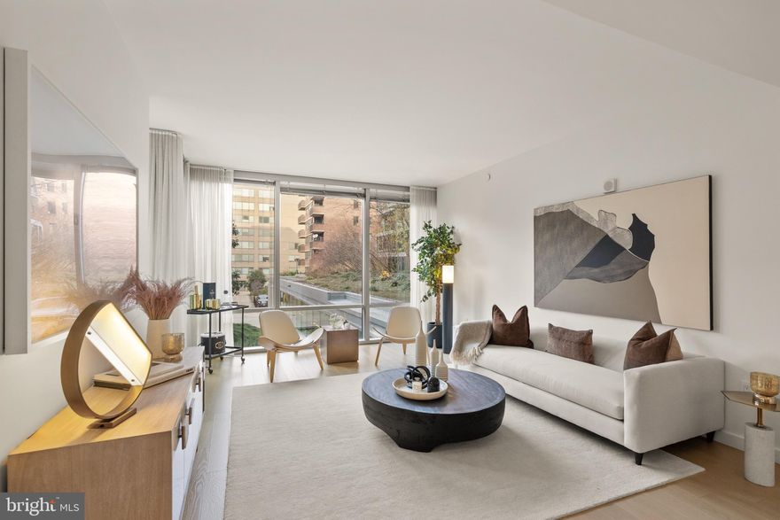 Quiet luxury meets effortless sophistication in Residence 27, an expansive two-bedroom, two-bathroom home at The Westlight, Washington’s premier address in the West End. Located on the second floor, this 1,782-square-foot north-facing residence offers a serene, private outlook with beautifully diffused natural light. 2025 HVAC. Floor-to-ceiling triple-glazed window walls deliver exceptional sound insulation and energy efficiency, creating a remarkably quiet retreat in the heart of the city. Wide-plank natural oak floors anchor the open living and dining spaces, while the sleek Euro-chic kitchen blends form and function with Italian high-gloss cabinetry, quartzite countertops, integrated Bosch and Thermador appliances, and natural-gas cooking vented directly outdoors—a rare luxury in city living. The primary suite is a private sanctuary featuring generous closet space and a spa-inspired bath appointed with Waterworks fixtures, a Toto washlet bidet, and a teak-slatted shower floor, offering a truly elevated daily experience. The second bedroom, equally well-scaled, provides flexibility for guests, a home office, or a refined secondary suite, with a full bathroom finished to the same elevated standard. A LEED Gold–certified building, Westlight prioritizes wellness with a HEPA-grade fresh-air system that delivers outside air directly to each residence—no recirculated air—setting a rare standard for urban health and comfort. Two garage spaces and private storage convey, with convenient access to EV charging stations within the building.
Residents enjoy white-glove, hotel-level service, including 24/7 concierge, doorman, porter, onsite engineer, and professional management. Amenities include a state-of-the-art fitness center, clubroom with catering kitchen, private grilling terraces, dog-wash station, bicycle storage, and D.C.’s only 25-meter rooftop pool, overlooking the city skyline.
Perfectly positioned between Georgetown, Dupont Circle, and Downtown, with Michelin-recognized dining, cultural landmarks, Whole Foods, Trader Joe’s, the Kennedy Center, and multiple Metro stations just moments away, Residence 27 offers a rare balance of privacy, prestige, and effortless city living.