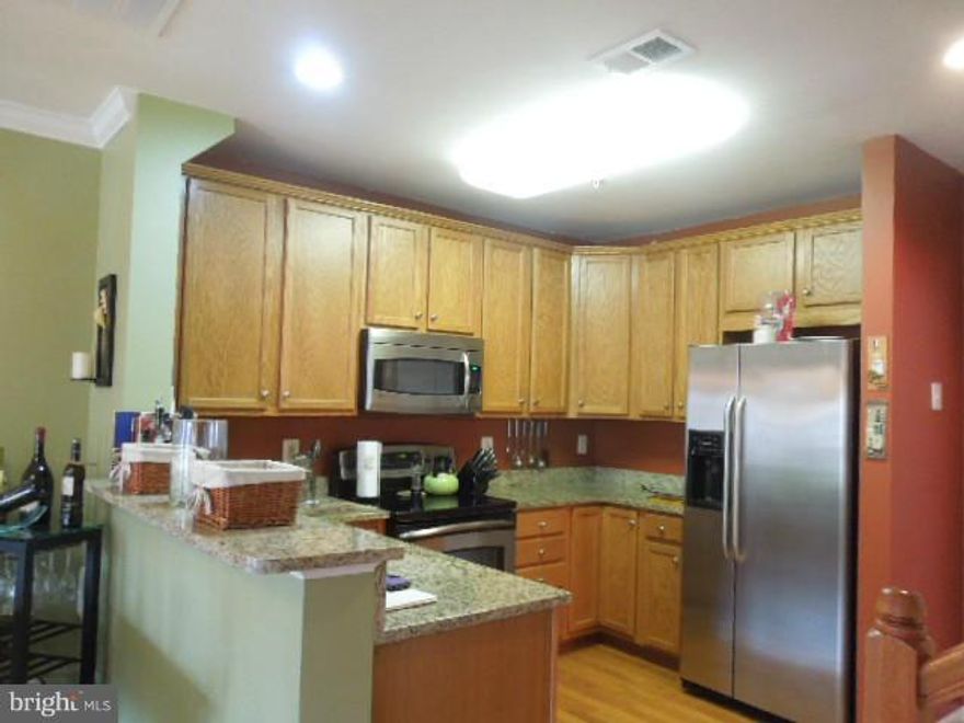 Ground Level 3 Bedroom Condo in the heart of beautiful Haymarket, minutes from shopping, hospital and Route 66! Hardwood floors, SS appliances,breakfast bar, Washer & Dryer, custom paint, private balcony, 1 car garage with drive way parking also. Gorgeous views, community pool and pavilion for picnics.