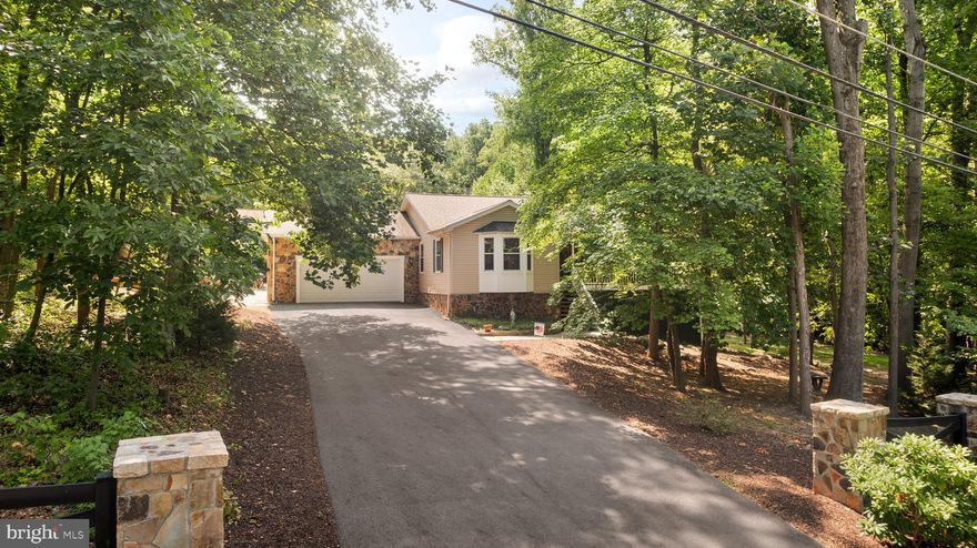 This is a true “ honey stop the car” property! The stunning curb appeal from the stone fencing and landscaping carries throughout the entire property! This all wrapped in stone over 3000 sqft home boosting 4 Beds and 3 full bathrooms on over 1.5 acres is the one you have been looking for.  With it being recently updated ( LVP Flooring, All 3 Futh Bathrooms, Kitchen, Stone Siding/ Fencing/ retaining wall and patio, Paved Driveway, Back Deck, Pool, Well, Septic just inspected and pumped, hot water heater, recessed lighting, the list goes !) you and move in with ease and begin enjoying all the luxuries. The interior of the home offers a spacious layout with an open Family Room, Kitchen and Dinning perfect to accommodate and entertain, access to your over sized 2 Car garage via new mud room w/ plenty of storage. A Primary Suite with attached Full Updated Bathroom and walk in closet. 2 Large Additional Guest bedrooms with ceiling fans, and another just updated full bathroom with double sinks and tiled tube/shower combo.  The walk out lower level basement features a huge game room, great room area with half stone wall, a larger 4th bedroom, full bathroom, laundry room, and finished storage space to use as you’d like.  Exterior home features- Spacious covered porch with 3 ceiling fans, Trex decking off your kitchen over looking private pool to relax and wined down in, separate all stone patio with stone retaining wall. Paved driveway with ample amount of parking.
All paved roads, high speed Internet, and no Hoa! Minutes to the Mountain Lake Club Bar and Grill and Beach.