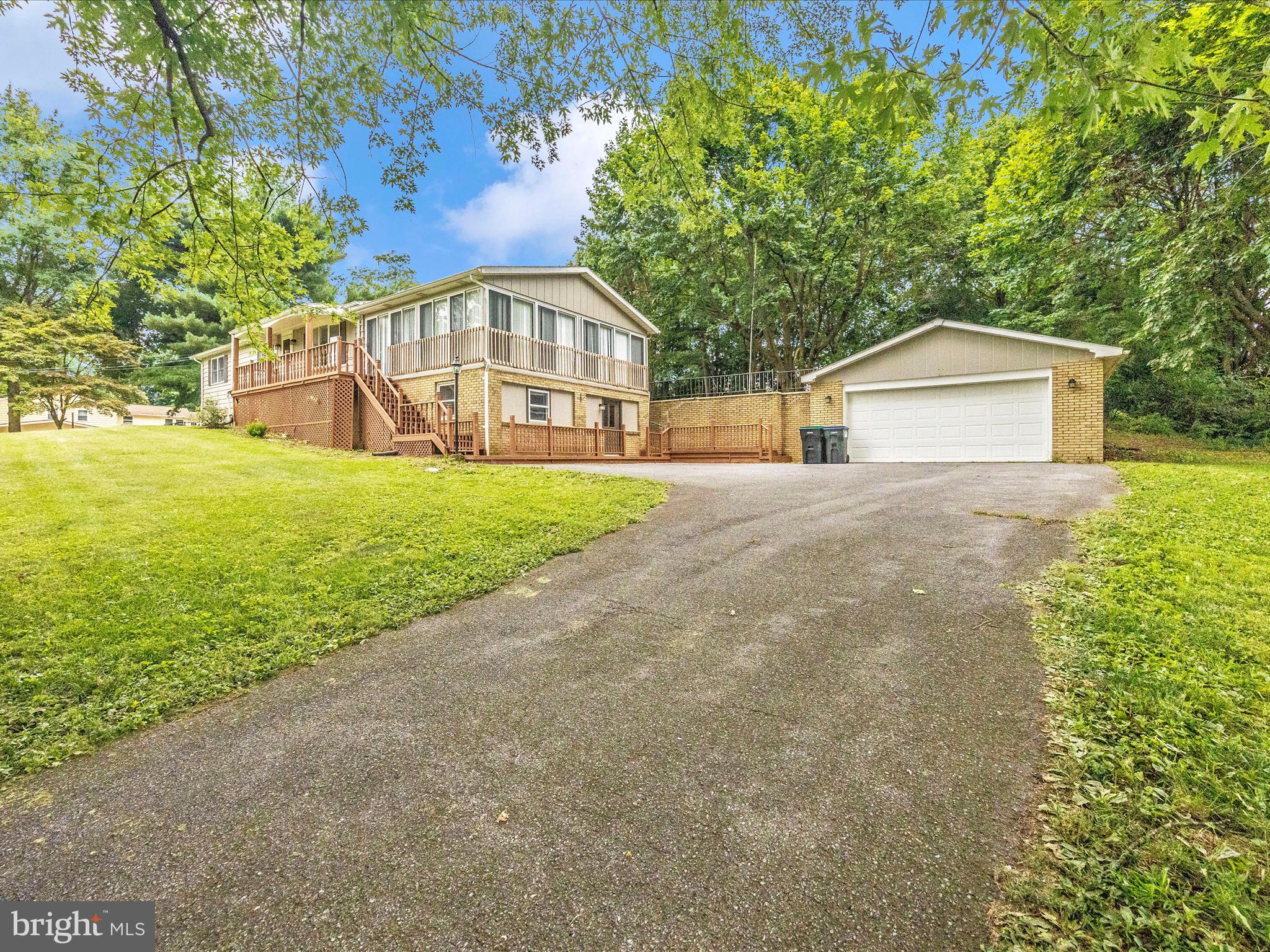 This large 3-bedroom home sets at the end of a long driveway where you can park in your 2-car garage. You'll enjoy the privacy given by all the mature trees situated along with board of the 1-arce+ property. The house has many unique feature including a vaulted ceiling in the living room. Many updates have been recently made which includes the roof and laminate floors. You enjoy having breakfast in the sunroom or the open concept dining area that is ideal for entertaining. If you like to cook (and even if you don't!) you'll love the stainless steel appliances, ample storage, and counter space galore. You might decide you never want to leave the sunroom with its ceiling fan and lovely view. The primary bedroom is made into a special retreat by its crown molding, natural light, large walk-in closet, and the attached bathroom with lots of storage and counterspace. Relax in the large shower. You have room for your family or an office in the two extra bedrooms. Your tour is not over yet! The lower level of the home features a family room equipped with a bar and a wood burning fireplace that you can cuddle in front of on chilly evenings. Love the outdoor life? Have a fun time on the patio where you can soak your stress away in a hot tub. You don't want to miss seeing this one-of-kind property that you could make your home. This one won't last long so be sure to schedule a showing today.