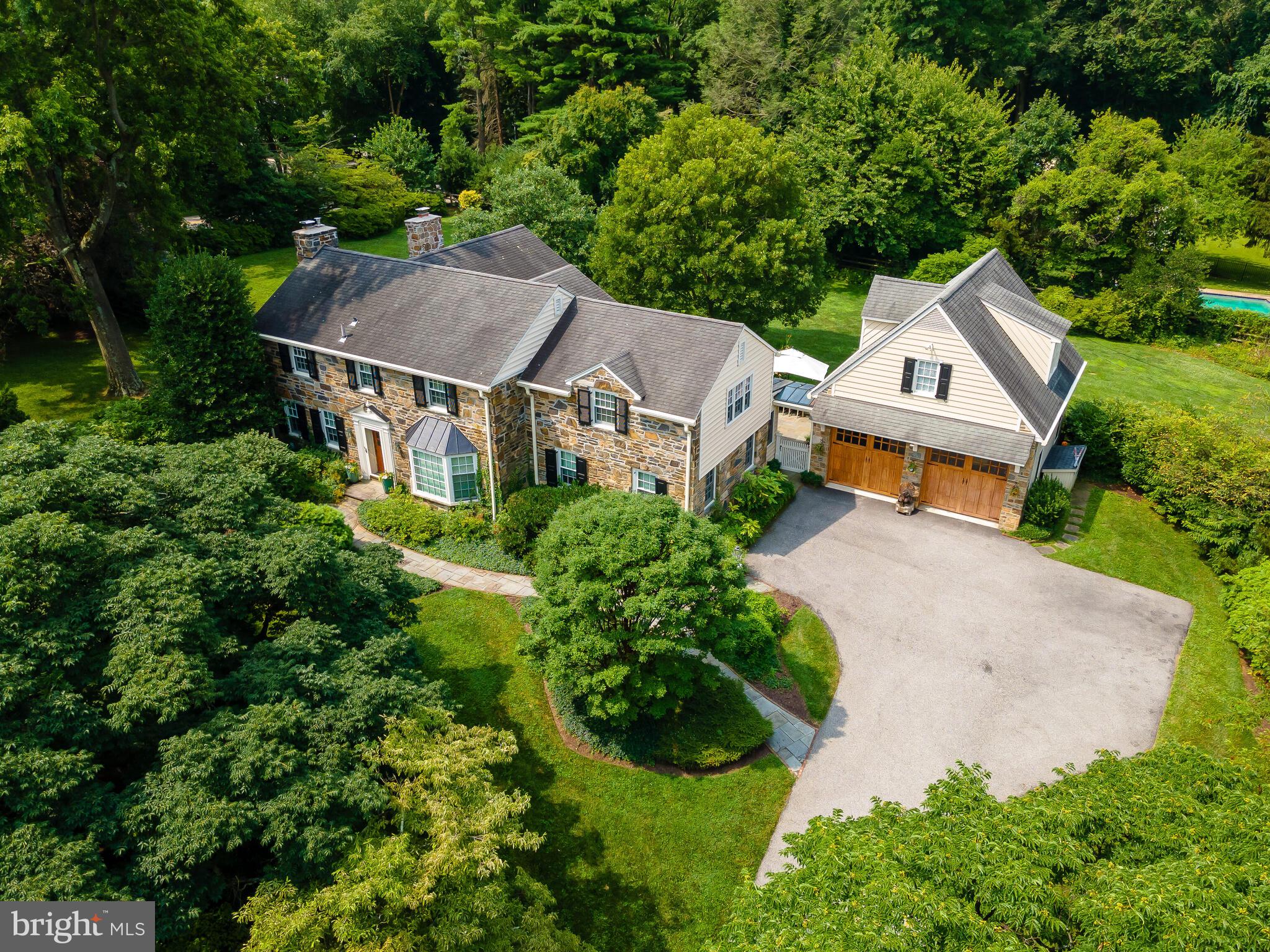 Classic Stone Colonial sited on an immaculately landscaped 1.16 acre level lot in the heart of Gladwyne. 4000 + sq. ft. of gracious living space with generously proportioned rooms, finished private space over the garage , exceptional flagstone patios , flat grassy fenced yard and lush gardens make this property desirable for any buyer. The house was renovated adding a detached two story garage, a new custom kitchen and family room, library/den, 1st floor laundry room and a dog room. The living room includes a lovely fireplace and outside entrance to a covered screened porch. The living room leads into the sun-filled family room with a second fireplace, access to the rear yard and is open to the eat-in kitchen with granite countertops and stainless appliances. The floor plan is wonderful for today's easy lifestyle but is still suitable for formal entertaining. The second floor has a lovely master suite with walk-in closets, a beautiful marble bath and large windows overlooking the property. There is an additional suite with private bath and two more bedrooms with a jack and Jill bath. There are hardwood floors throughout the house and almost all new windows. With exceptional Lower Merion Schools , an easy commute to Center City or the airport, and room over the garage for a private office this property has it all!
Showings begin Tuesday, 8/17/2021