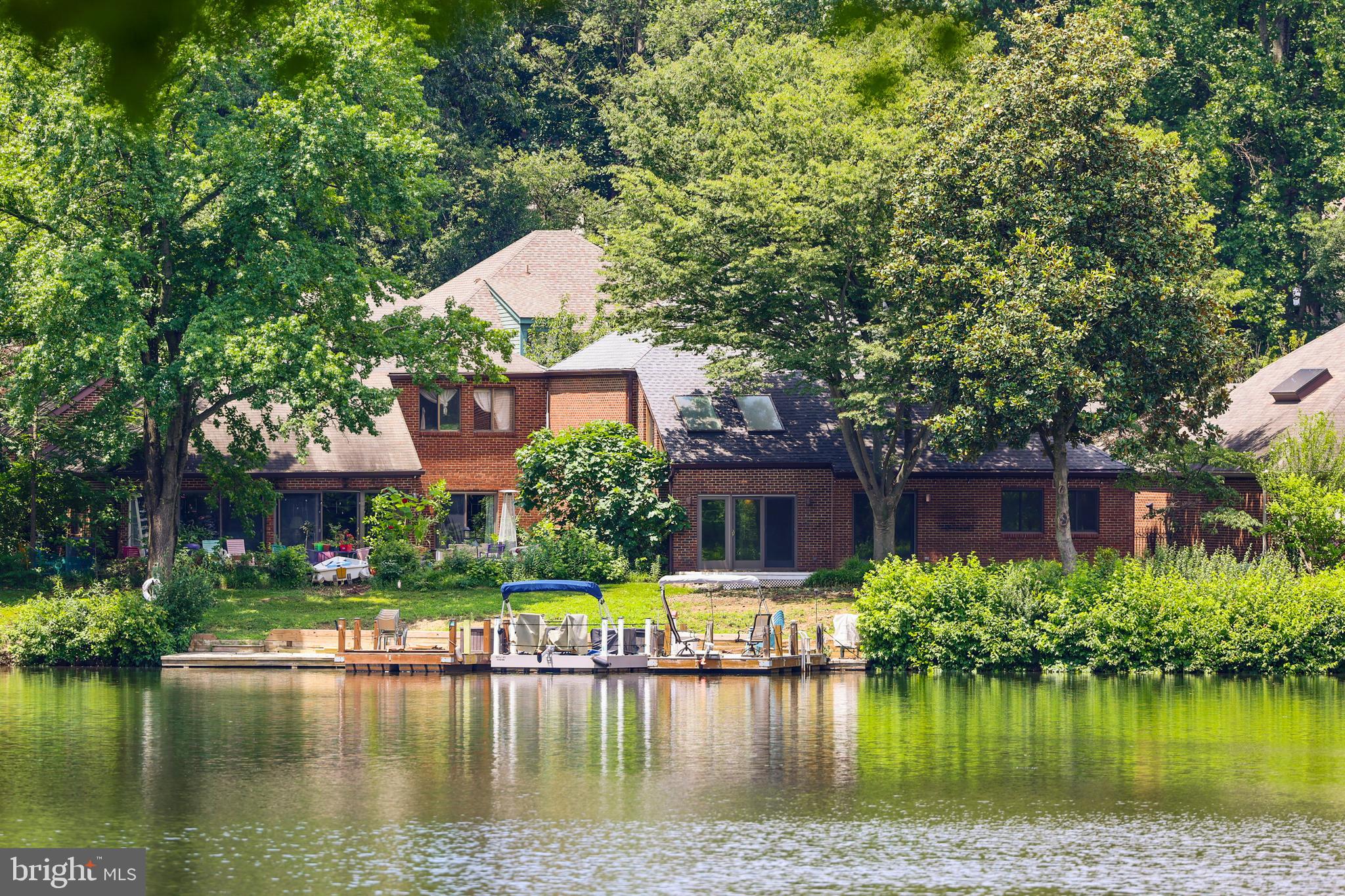 THE BEST WATER VIEWS ON LAKE THOREAU!!! A contemporary all-brick home in one of the best waterfront locations in Reston! Enjoy water views from the living room with white oak flooring, soaring two-story ceiling heights and cozy fireplace. MAIN-LEVEL primary bedroom with gorgeous water views and doors that lead out to deck overlooking the lake, soaring ceiling heights and ensuite primary bathroom. Two additional bedrooms and a remodeled hall bathroom are located upstairs. The kitchen offers stainless steel appliances and opens to a sizable yet cozy flagstone courtyard. The detached 2-car garage offers enclosed parking plus additional storage.
All located within minutes to Reston Town Center, and an excellent commuter location just minutes to two Silver Line metro stations, Rt. 267, Reston Parkway and Rt. 286. Enjoy the lakefront privileges, over 55 miles of walking trails, 48 tennis courts, 15 pools and so much more in the heart of Reston!