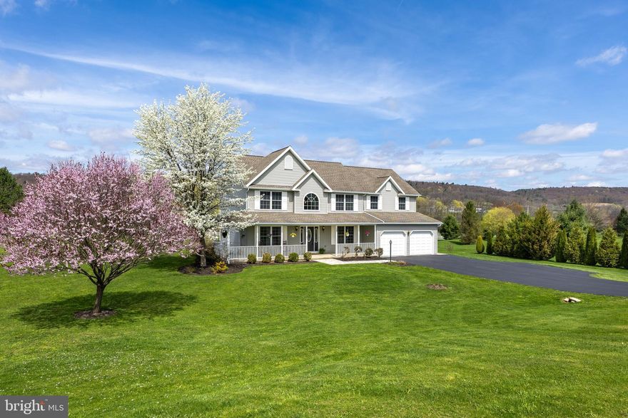 Pristine and spacious, this beautiful two-story home sits on a stunning 0.87-acre lot backing to neighborhood green space, offering privacy and peaceful views in the tranquil setting of the Trotter Farms development in the State College School District. Enjoy quiet mornings on the charming wrap-around front porch and serene evenings on the back stone patio with breathtaking sunset and mountain ridge views.  Nature lovers will also appreciate the sustainability features of this unique home.  This environmentally friendly GREEN home includes Energy Star-rated appliances, low-E glass windows, and a south-facing orientation that maximizes natural light and energy efficiency throughout the year. 

Inside, you'll find a welcoming two-story foyer, gleaming hardwood floors and a freshly painted interior. The main level features a spacious living room and formal dining room, perfect for entertaining. The large eat-in kitchen boasts maple cabinetry, granite countertops, glass tile backsplash, under-cabinet lighting and new stainless steel Energy Star appliances. The adjacent family room includes brand-new luxury vinyl plank flooring. A front office, powder room, and oversized 2-car garage complete the main floor.

Upstairs, the light-filled owner's suite offers new LVP flooring, a sitting area, large walk-in closet, and a luxurious ensuite bath with dual cherry vanities, tiled floors, a jetted tub and separate shower. Three additional bedrooms (two with new carpet), a full tiled bath, and a convenient laundry closet complete the upper level.

The full unfinished basement features an egress window and bathroom rough-ins, ready to be finished into additional living space, a 5th bedroom, home gym, a second office- you choose! Outside, appreciate the mature trees, beautiful landscaping, and expansive lawn, along with access to neighborhood walking trails, a park, and nearby state game lands for year-round recreation.

Just minutes from North End shopping, restaurants, schools, and medical facilities, and under 15 minutes to Penn State and downtown State College, this move-in ready home blends efficiency, privacy, and convenience in a serene countryside setting.