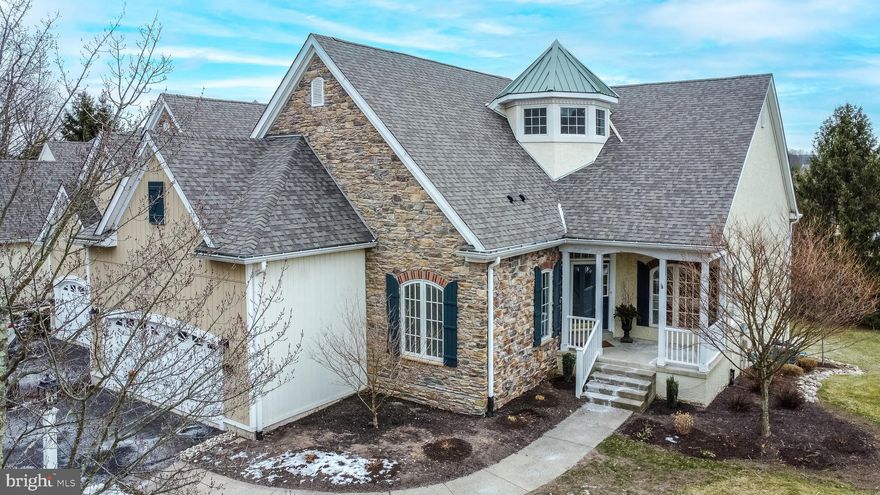 Welcome home! This immaculate, move-in-ready end-unit carriage home, built by Deluca, feels like new construction with over $117,000 in recent updates both inside and out. Located on a tranquil cul-de-sac with serene pastoral views, within the prestigious Stone Ridge community, this spacious three-bedroom, three-and-a-half-bathroom home offers 4,318 square feet of beautifully finished above-grade living space. It includes a stunning, daylight walkout basement with a natural gas fireplace. Enjoy maintenance-free living, just a short stroll from charming Peddler’s Village, a quick drive to New Hope, and within the highly regarded Central Bucks School District.
As you approach the home, you will be greeted by a charming covered front patio. Upon entering, you will immediately notice the grand two-story foyer, gleaming new hardwood floors, an abundance of natural light, and a warm neutral color palette throughout. An elegant dining room, featuring a large arched window, adjoins the updated gourmet eat-in kitchen—a chef’s dream with gorgeous new quartz countertops and island with pendant lights, tile backsplash, ample storage space, a Wolf six-burner natural gas cooktop with a stainless steel exhaust hood, double wall ovens, microwave, Sub Zero refrigerator, wine cooler, new Bosch dishwasher, trash compactor, and a convenient walk-in pantry. Off the kitchen, an expansive low-maintenance composite deck offers stunning views and provides a perfect spot to unwind or dine alfresco. The kitchen flows seamlessly into the spacious great room, which boasts two skylights, a natural gas fireplace, and a cozy area ideal for entertaining.
The main-floor primary bedroom features a generous walk-in closet with custom built-ins, and a newly remodeled ensuite bathroom, offering a spa-like retreat. It includes a luxurious shower with double rain heads, a double vanity with an exquisite marble countertop, and radiant heated floors. A guest bedroom with an ensuite bathroom, the laundry room with wash sink, mudroom with garage access, complete the first floor.
The lower level features a daylight basement, providing extra living space with higher ceilings. It includes a recreation room with a natural gas fireplace, a third bedroom with an ensuite full bathroom, a wet bar, a half bath, a spacious storage area, and access to the two-car garage with an extra height ceiling and equipped with storage cabinets. Step outside to the newly installed paver patio area for additional outdoor enjoyment.
Recent updates over the past two years include a new kitchen, primary bathroom with radiant heat, roof, skylights, custom front window, exterior paint, light post, street paving, stucco, hardwood floors, rear paver patio, a new tankless water heater, new Bosch dishwasher, garage exterior, and landscaping.
Perfectly situated in vibrant Doylestown, this home is close to an array of shops, restaurants, entertainment venues, outdoor parks, and trails, with easy access to New Hope and public transportation. Do not miss your chance to see this exceptional property—schedule your appointment now and make this dream home yours!