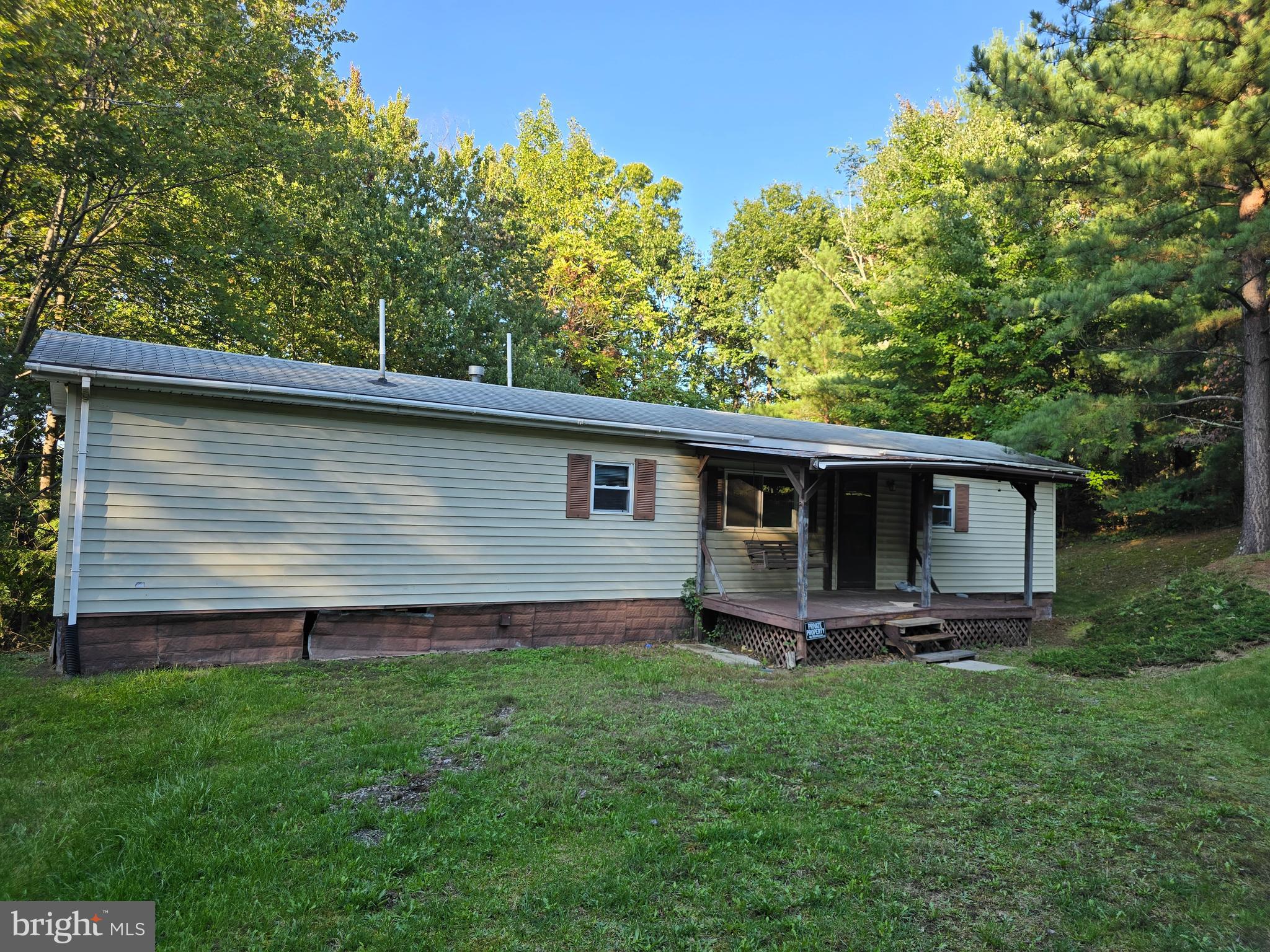Mobile Home with 14 x 30 addition. 3 bedrooms, 1 bath. Covered front porch, rear porch off kitchen. Shed in rear for additional storage with electric. Located on 7.82 wooded acres on dead end road. Small rural subdivision. Easy access. Approximately 18 miles (30 minutes) to Winchester. Property is being strictly sold in "as is" condition. Road maintenance agreement is $100/yearly.