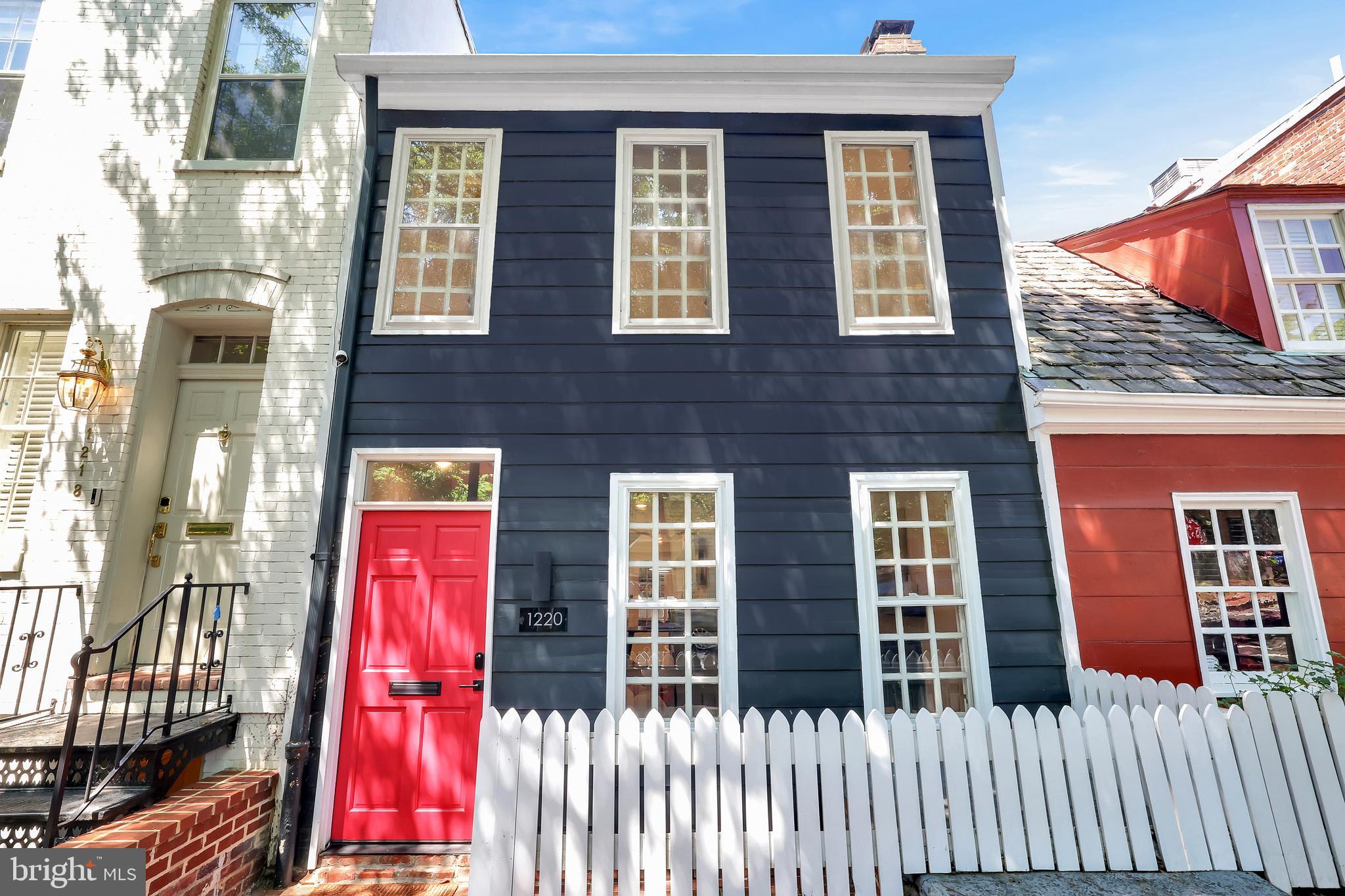 (OPEN SUN. 6/15 1-3 PM) Welcome to 1220 28th Street NW, a striking marriage of heritage and modern sophistication in the heart of Georgetown’s East Village. Tucked away just steps from M St and Rose Park, this iconic red-doored Federal-style residence has been completely reimagined to meet the demands of discerning 21st-century living, without sacrificing an ounce of its storied soul.
Originally built in the 1800s, the home carries the kind of historical pedigree rarely found outside the walls of Washington’s most treasured institutions. Once home to a family whose lineage intersects with American presidential legacy, 1220 28th embodies prestige and permanence — all with the comfort, ease, and efficiency of a brand-new build.
Inside, the 3-bedroom, 2.5-bath layout has been thoughtfully opened and elevated, introducing a fluid floor plan that maximizes light, flow, and functionality. The main level stuns with new hardwood floors, an elegant new powder room, and a showpiece chef’s kitchen outfitted with top-tier appliances such as Fisher & Paykel, a dual-drawer dishwasher, quartz countertops, designer lighting, and custom cabinetry. A preserved wood-burning stove adds charm and warmth — an intentional nod to the home’s historic character.
From the living area, French doors invite you to a serene bluestone patio — newly hardscaped and perfect for hosting under string lights or savoring a quiet moment away from the city’s buzz.
Upstairs, natural light floods each room, including the tranquil primary suite, a secondary bedroom with a private en-suite bath, and a versatile third bedroom ideal as an office, nursery, or guest suite. Every bathroom has been beautifully reimagined with timeless finishes, and the bonus finished attic offers a rare flex space bathed in skylight — ideal for creative pursuits or storage.
Mechanical updates include new HVAC, updated roof, electrical upgrades, and premium finish work throughout, offering the feel of new construction within the historic walls of a legacy home.
Located just moments from Rose Park, M Street’s celebrated boutiques and cafés, and the Georgetown Waterfront, this home offers the best of D.C. living — refined, walkable, and effortlessly connected to the city’s cultural and political heartbeat. With a walk score of 97 and perfectly positioned to take advantage of its proximity to the West End, Dupont Circle, and Foggy Bottom, this is truly the perfect place to call home.
