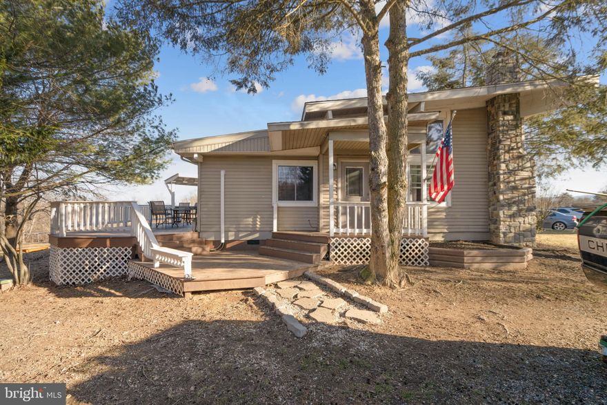 Charming 3 bedroom 2 full bath  Lake Cottage in the serene community of Lake Holiday! Ideally situated near the front gate, this home offers both convenience, privacy and plenty of space for  your outdoor entertaining needs.  Inside, The efficient kitchen features sleek quartz countertops and fresh appliances. Newly installed heat pump mini-splits provide individualized climate control in every living space, including each of the 3 bedrooms. The living, dining, and kitchen areas are enhanced with new luxury vinyl plank flooring, while the vaulted ceiling with exposed beams give the property a spacious feel.  The stone hearth feature is ready for a cozy  wood stove insert while the updated hall bath includes a new vanity, commode, and flooring. Step outside to a spacious wraparound deck, perfect for relaxing or entertaining, overlooking a level backyard with scenic views. This charming home is an excellent choice for first-time buyers or as a vacation retreat in Lake Holiday’s exclusive 240-acre gated community. Residents enjoy access to multiple sandy beaches, basketball, tennis, and volleyball courts, a fitness center, walking and hiking trails, playgrounds, dog parks, and more. Conveniently located just 20 minutes from Winchester.  Priced to sell!!